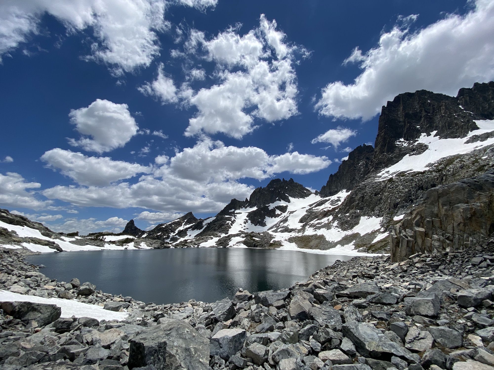 A small, deep blue lake surrounded by rocks