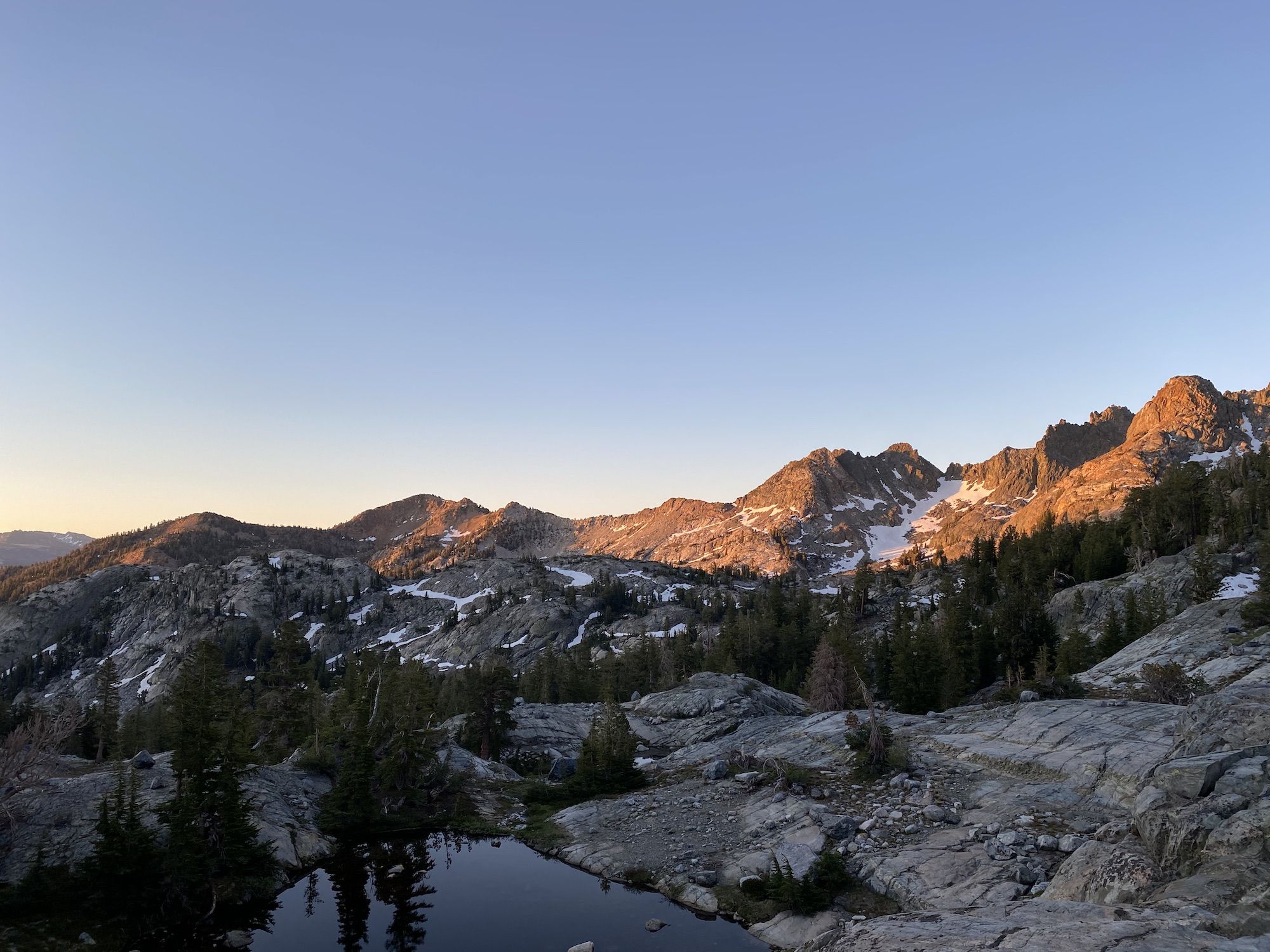 A soft pink light illuminating moutains