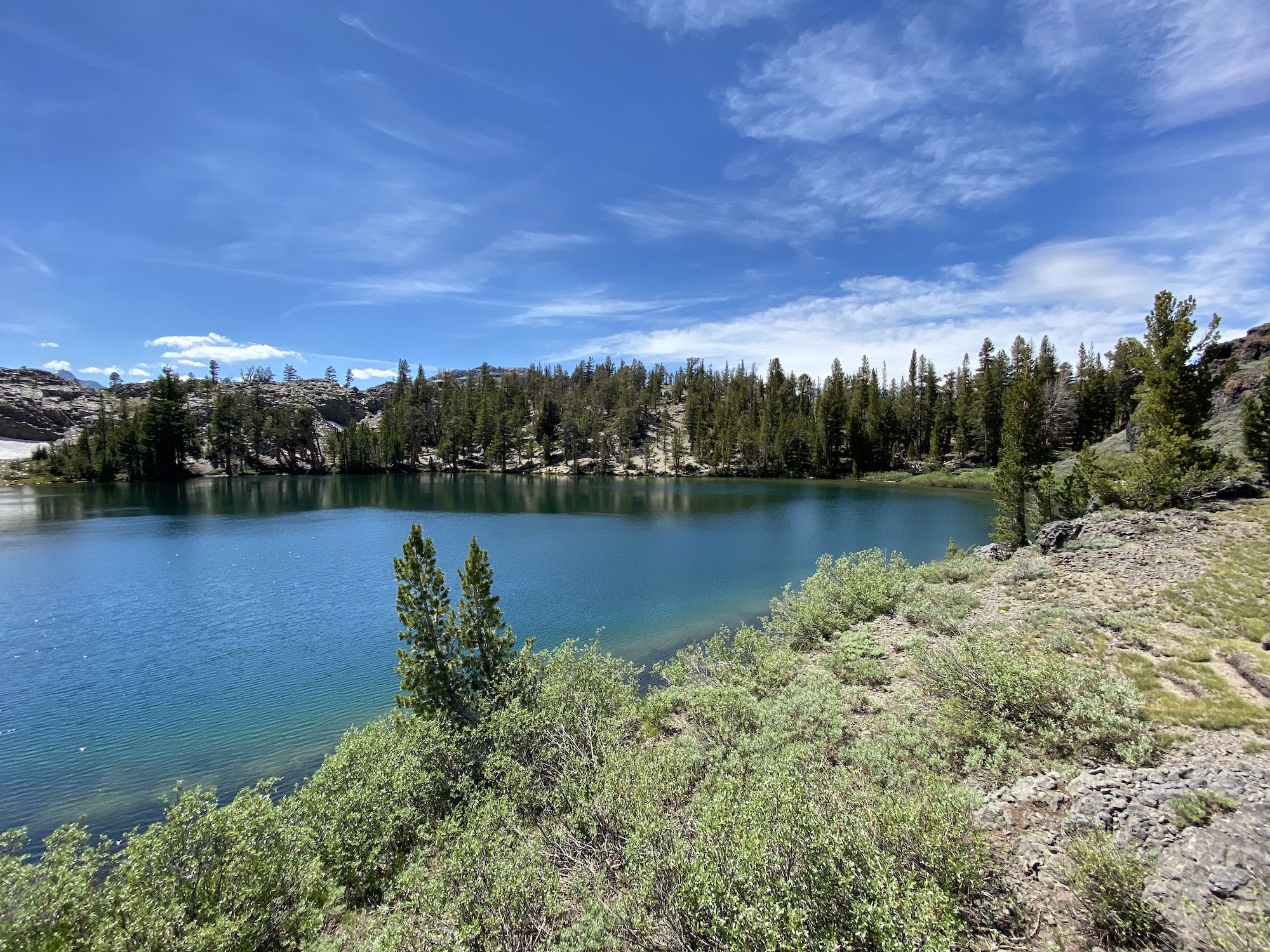 A deep turquoise lake surrounded by trees