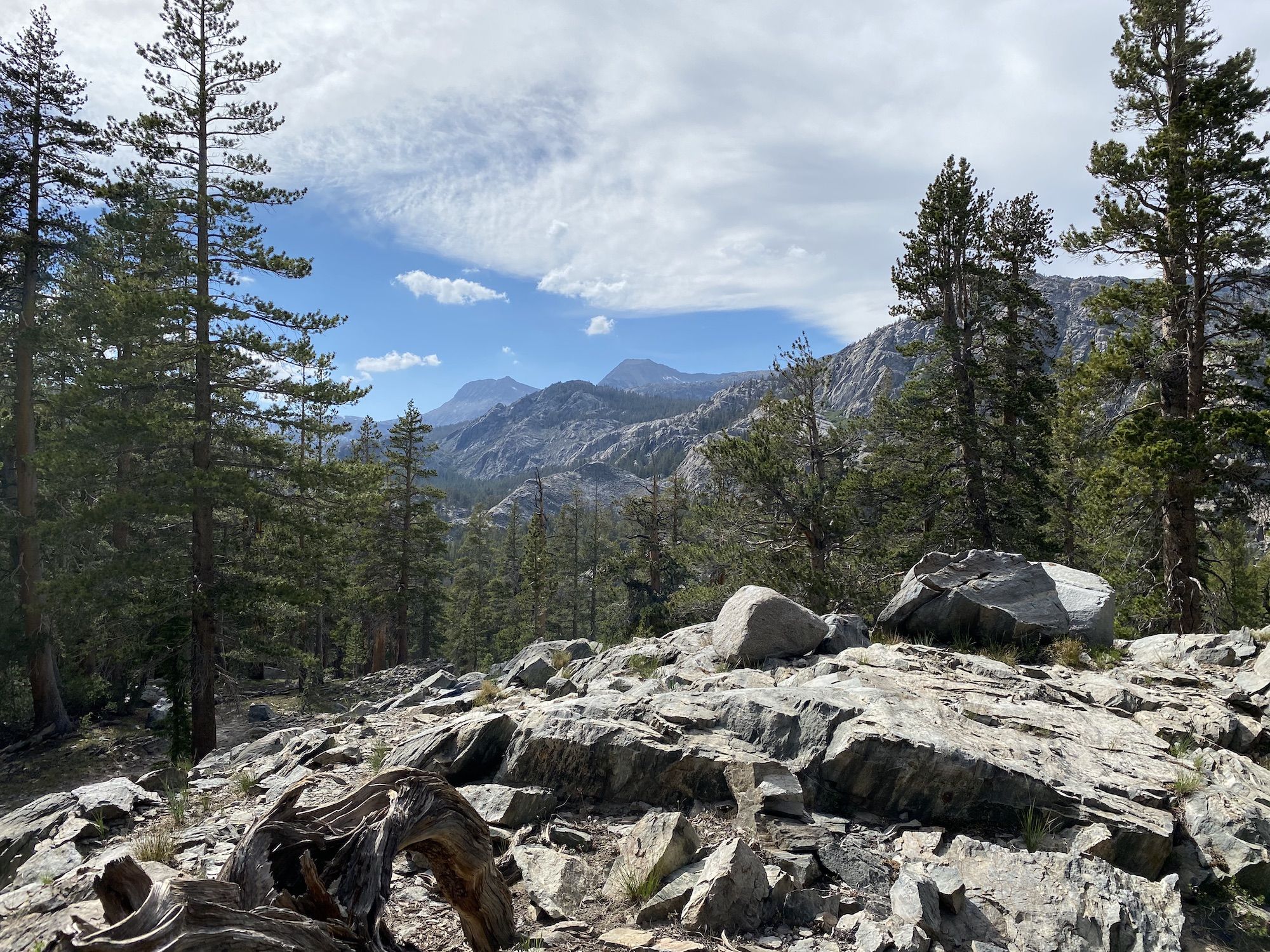 A granite cliff with views over distant mountains