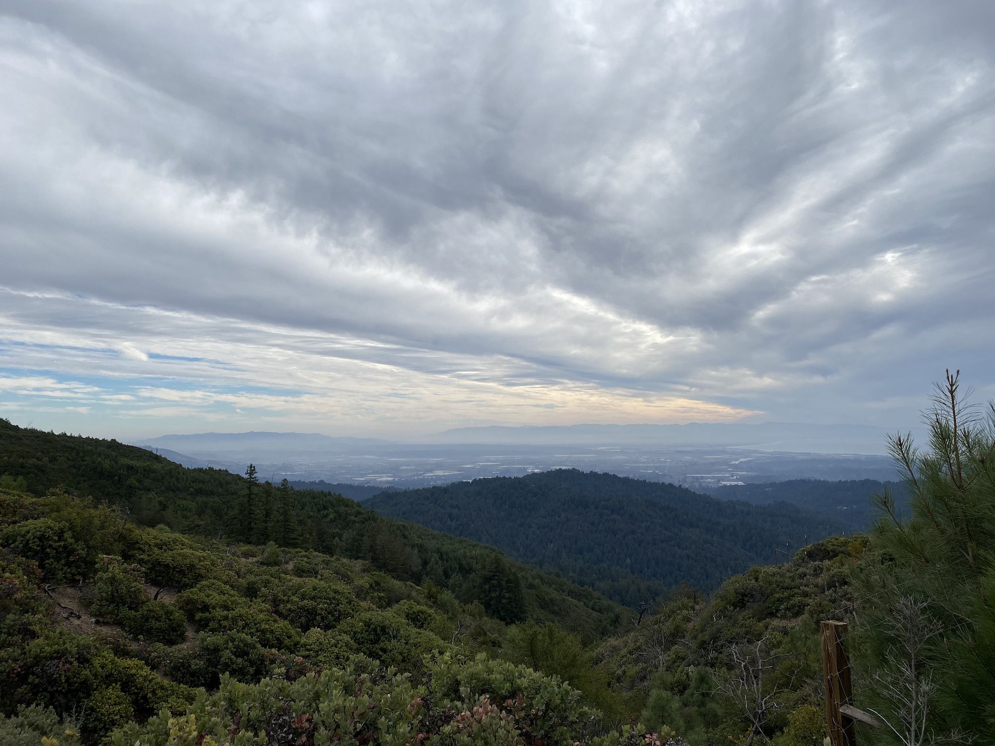 Green hills in the foreground, Monterey Bay in the background. 