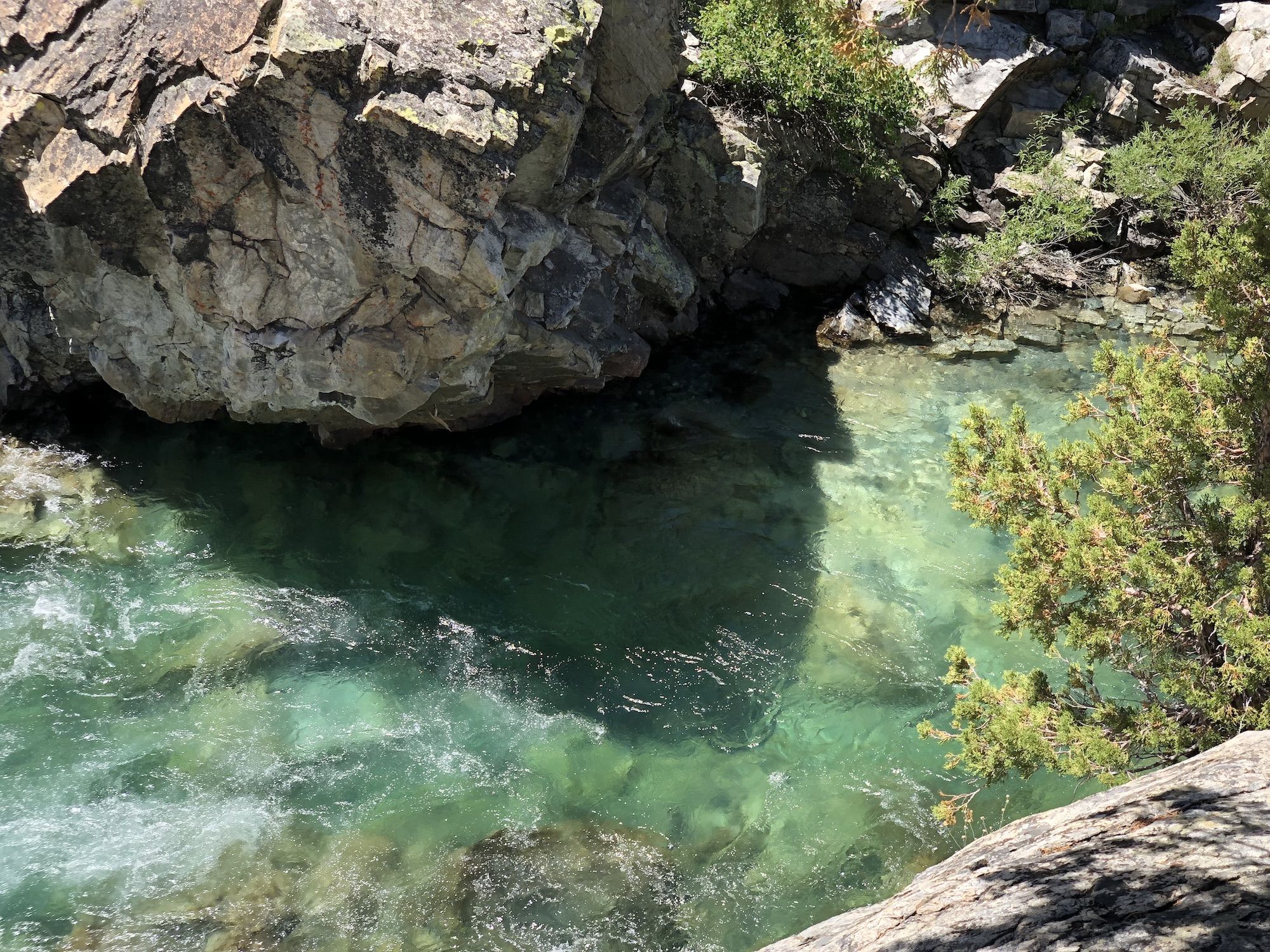 A deep pool of water in a river gorge.