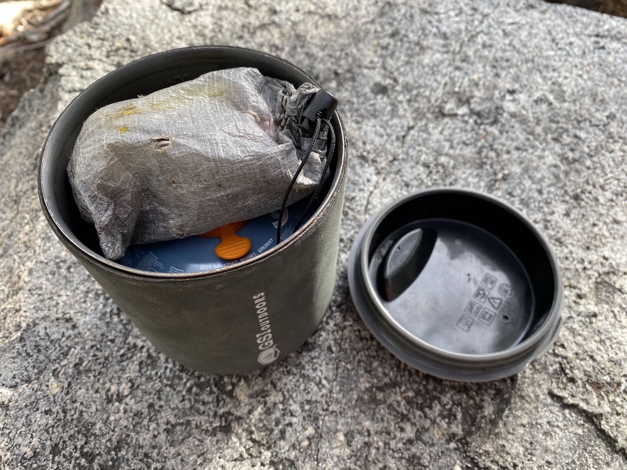 A Halulite Minimalist pot with a gas canister and a stove inside. 