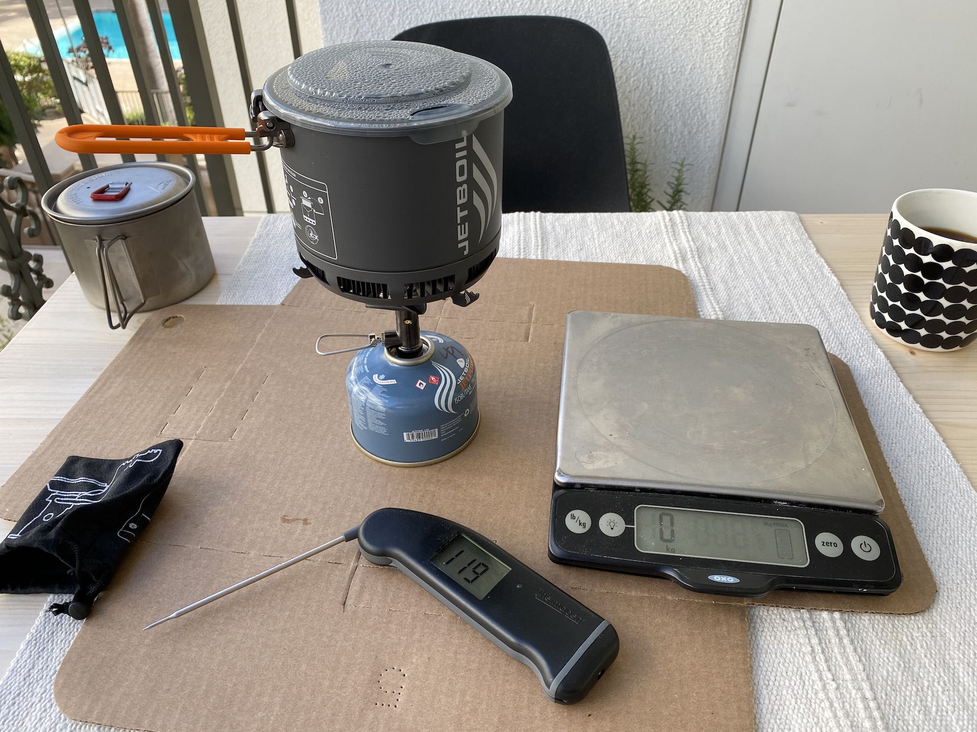 The test setup: Jetboil Stash stove, a digital scale, and a thermometer.