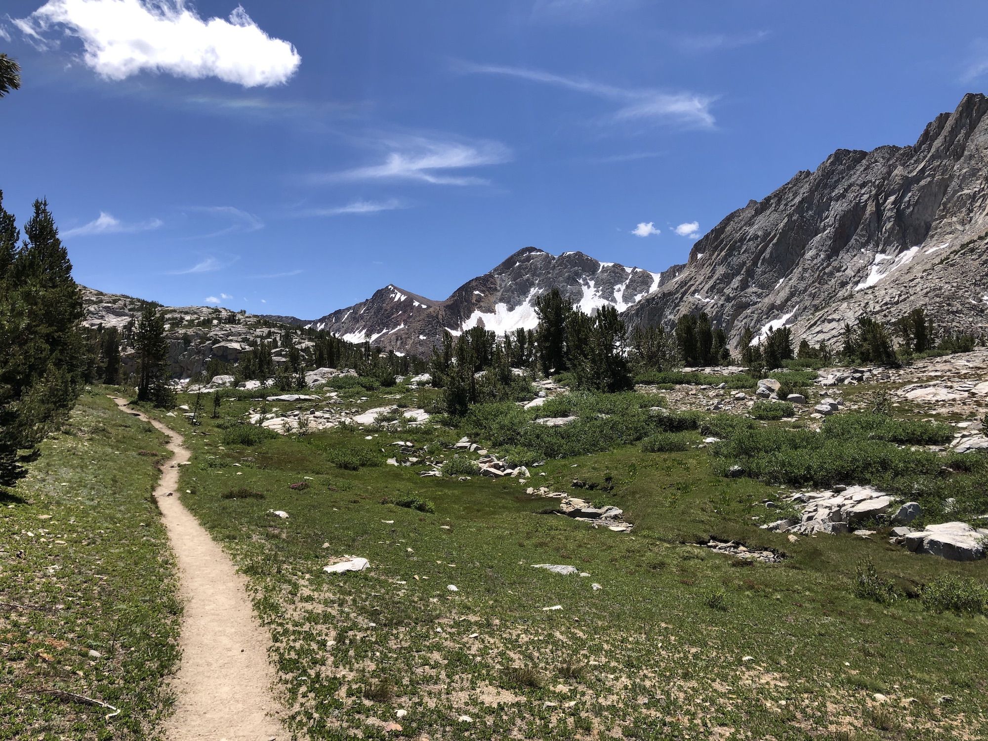 A dirt path following a small stream to the right. 