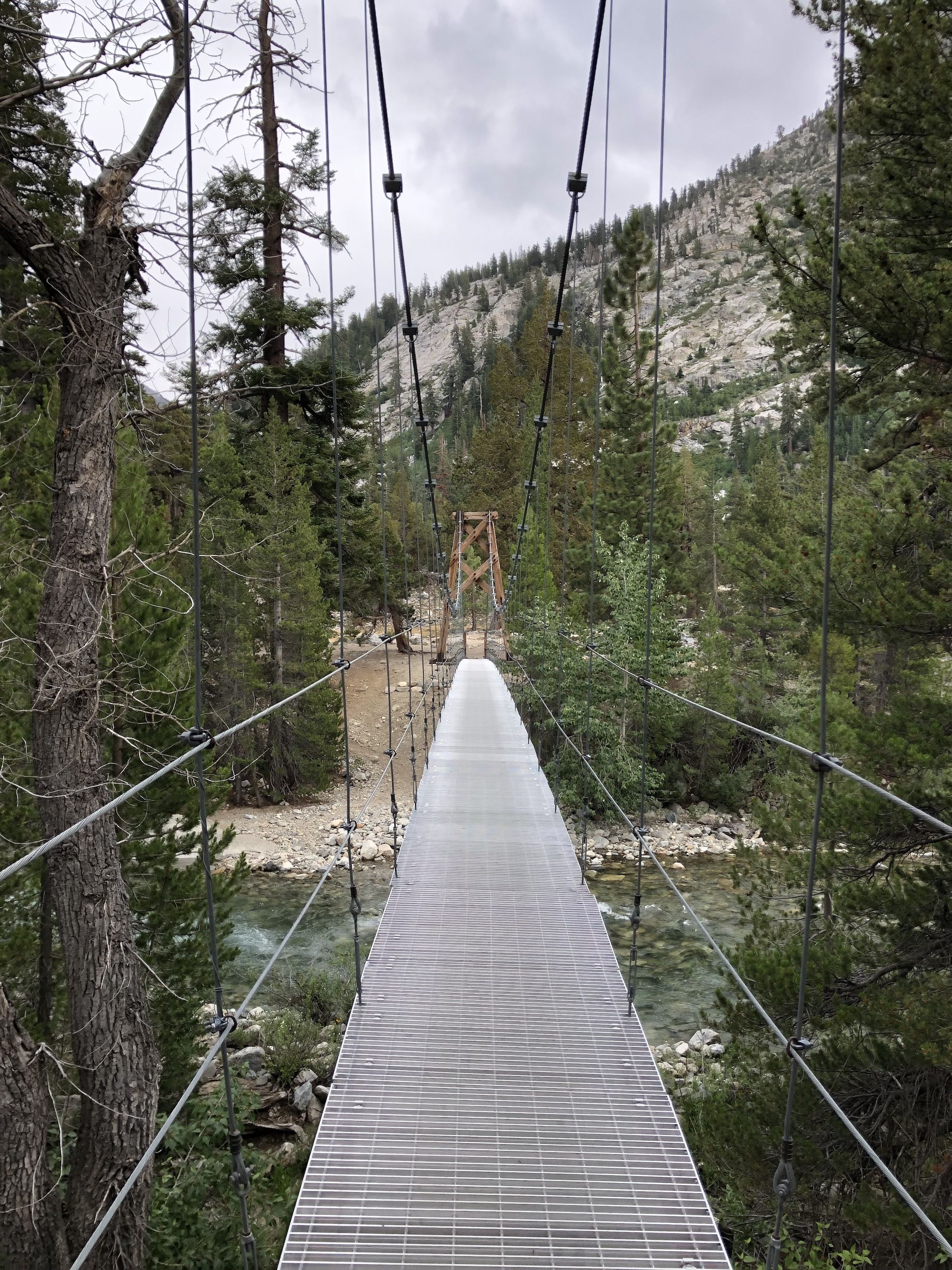 A suspension bridge over a deep river.