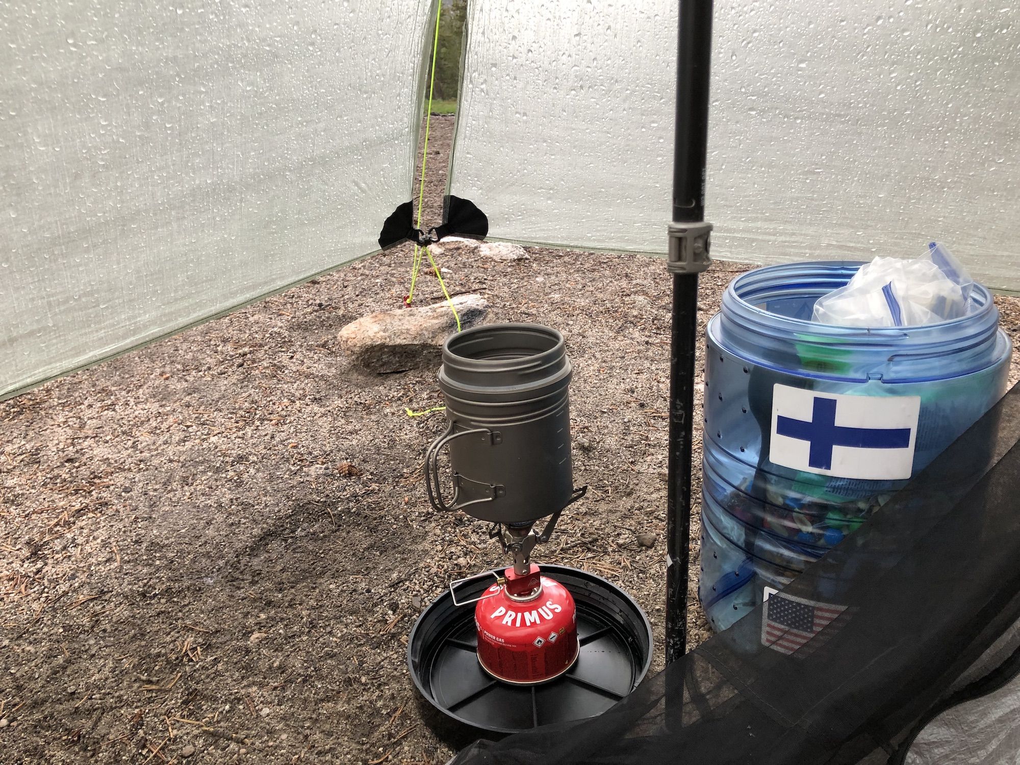 A titanium cup on a small stove attached to a gas canister. 