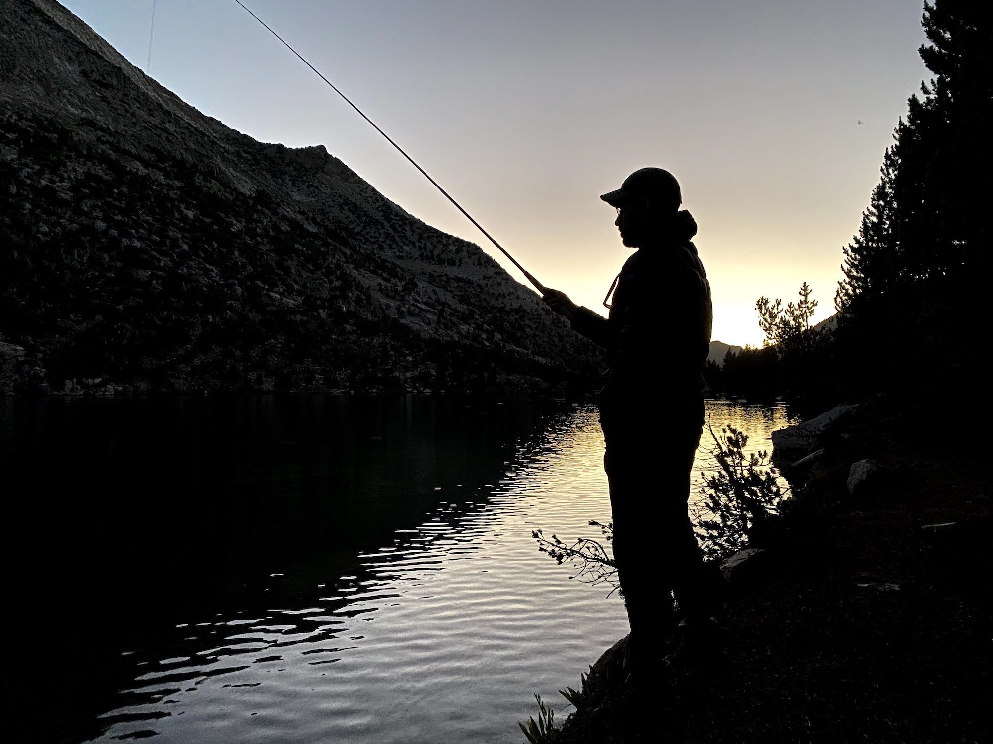 A man fly fishing at Charlotte Lake in Kings Canyon