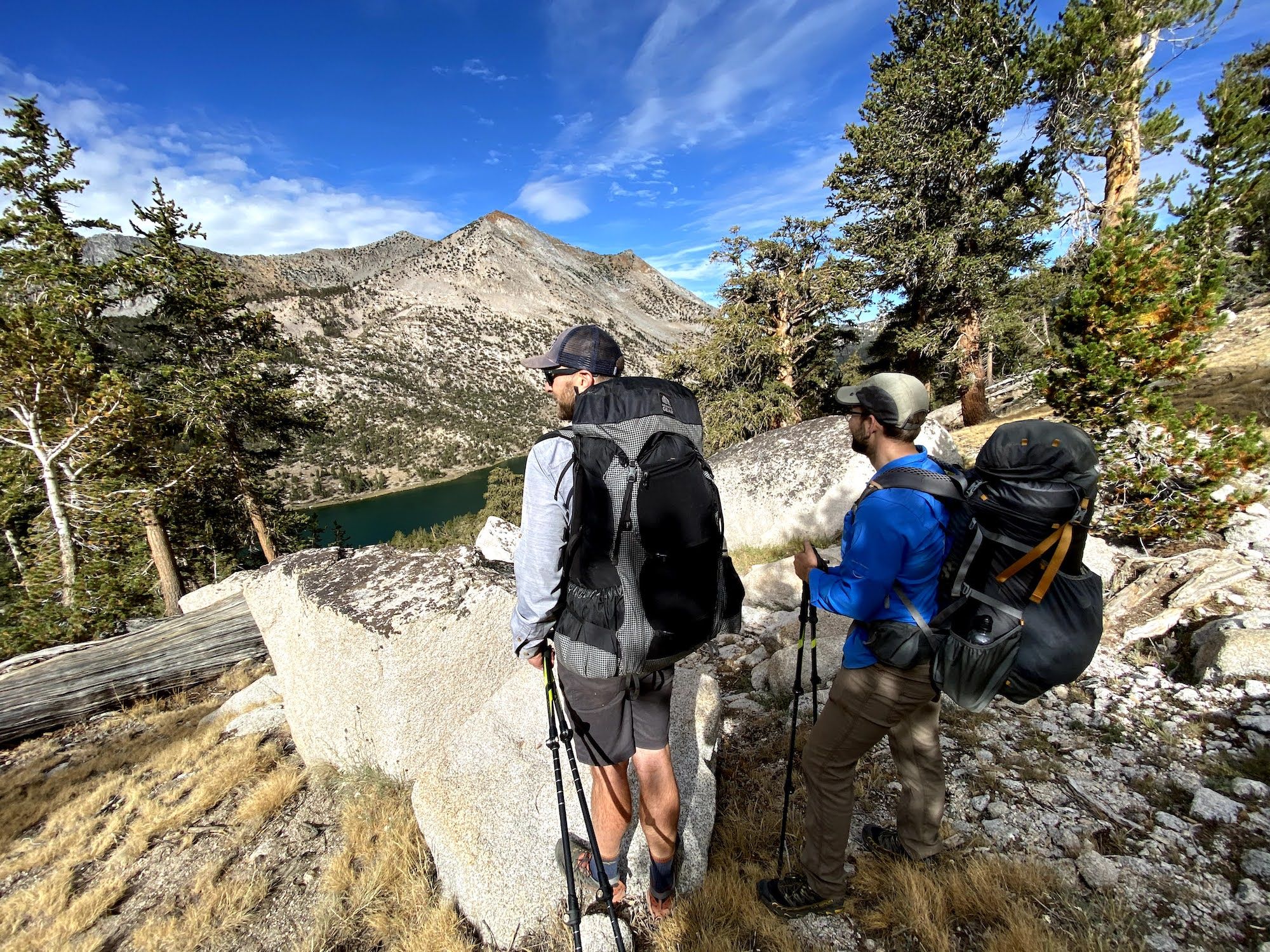 Two backpackers looking down at Charlotte Lake