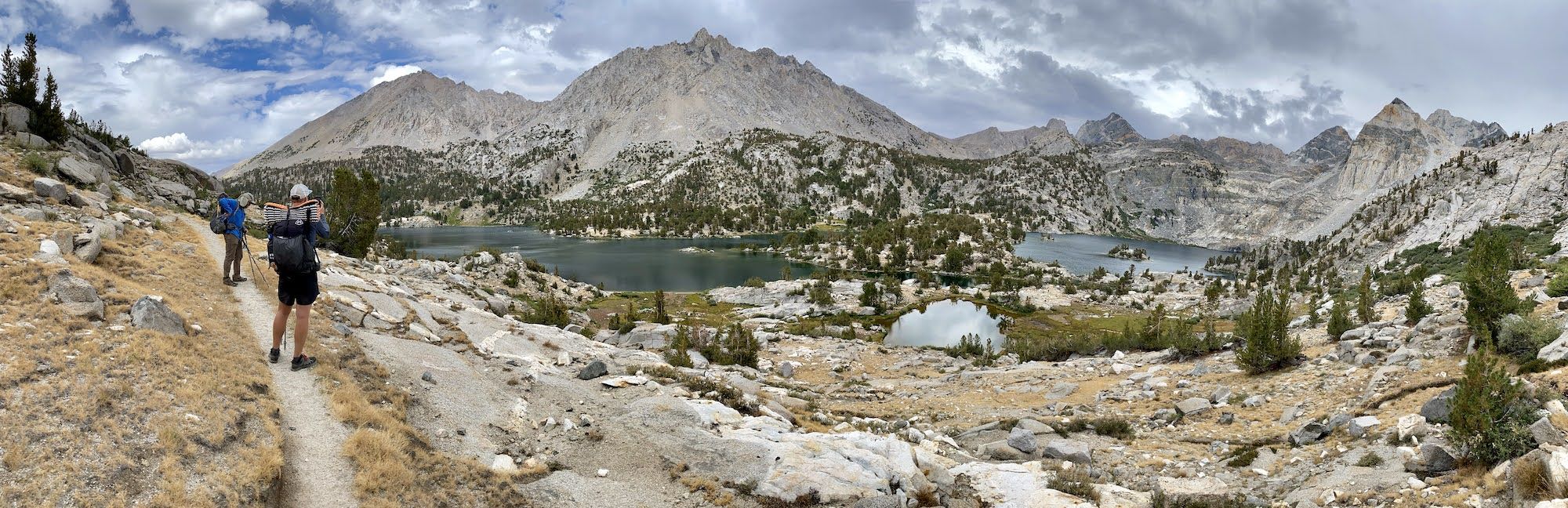 Two backpackers overlooking Rae Lakes on the 60 Lakes Basin trail.