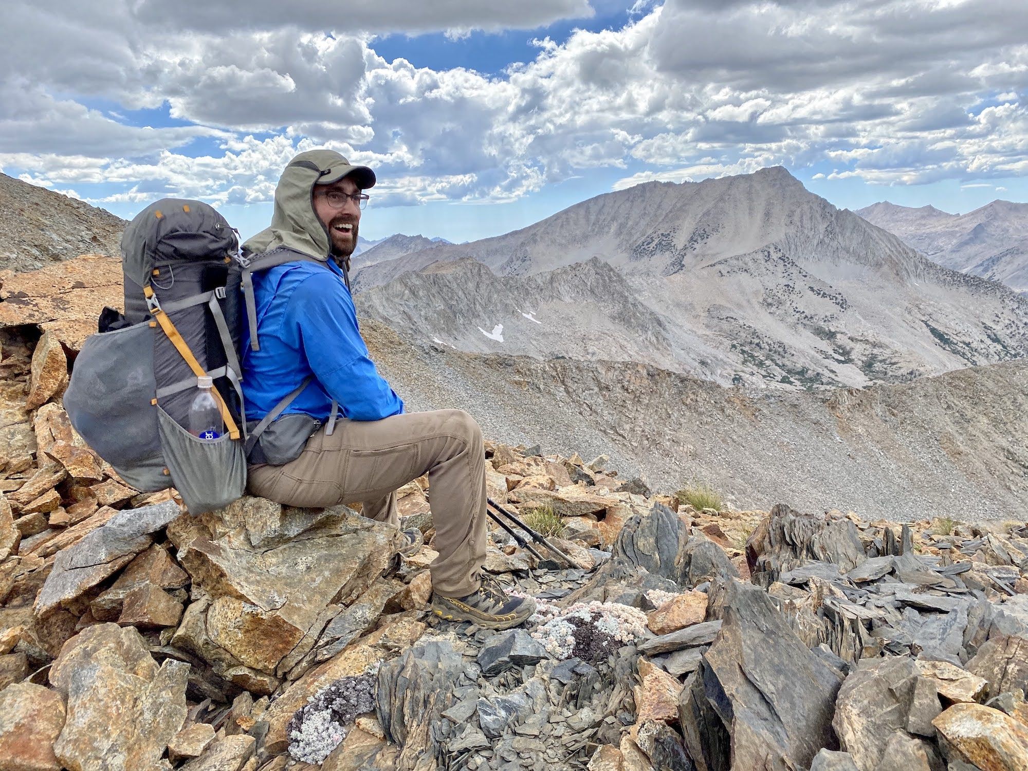 A man sitting on top of White fork Pass wearing a backpack