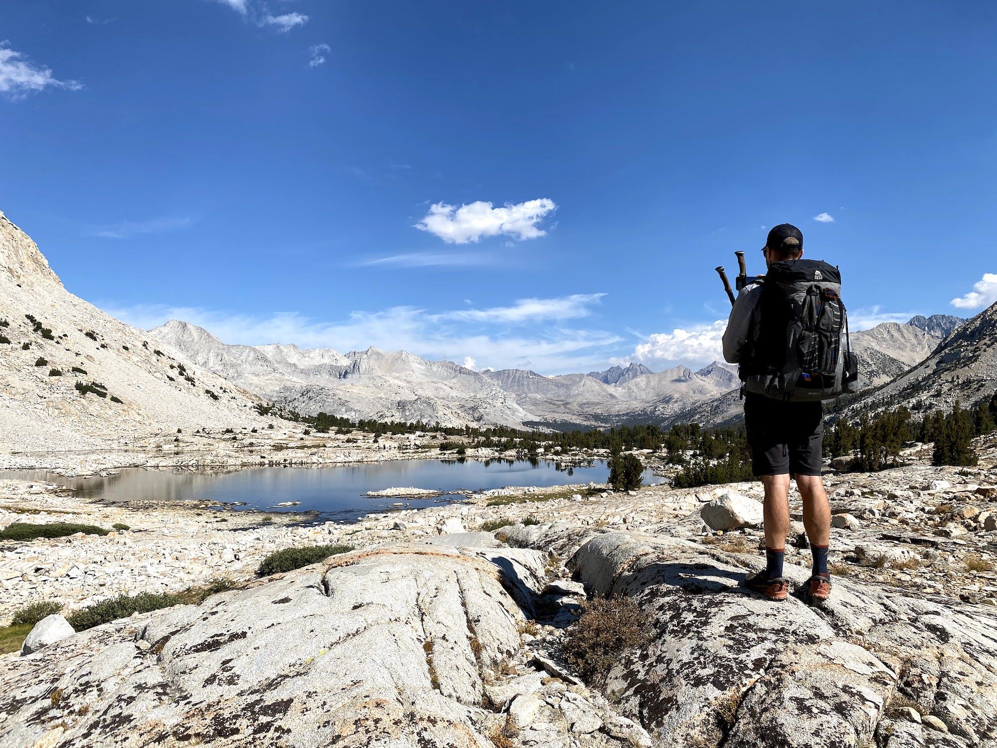 A man looking at a lake in the distance