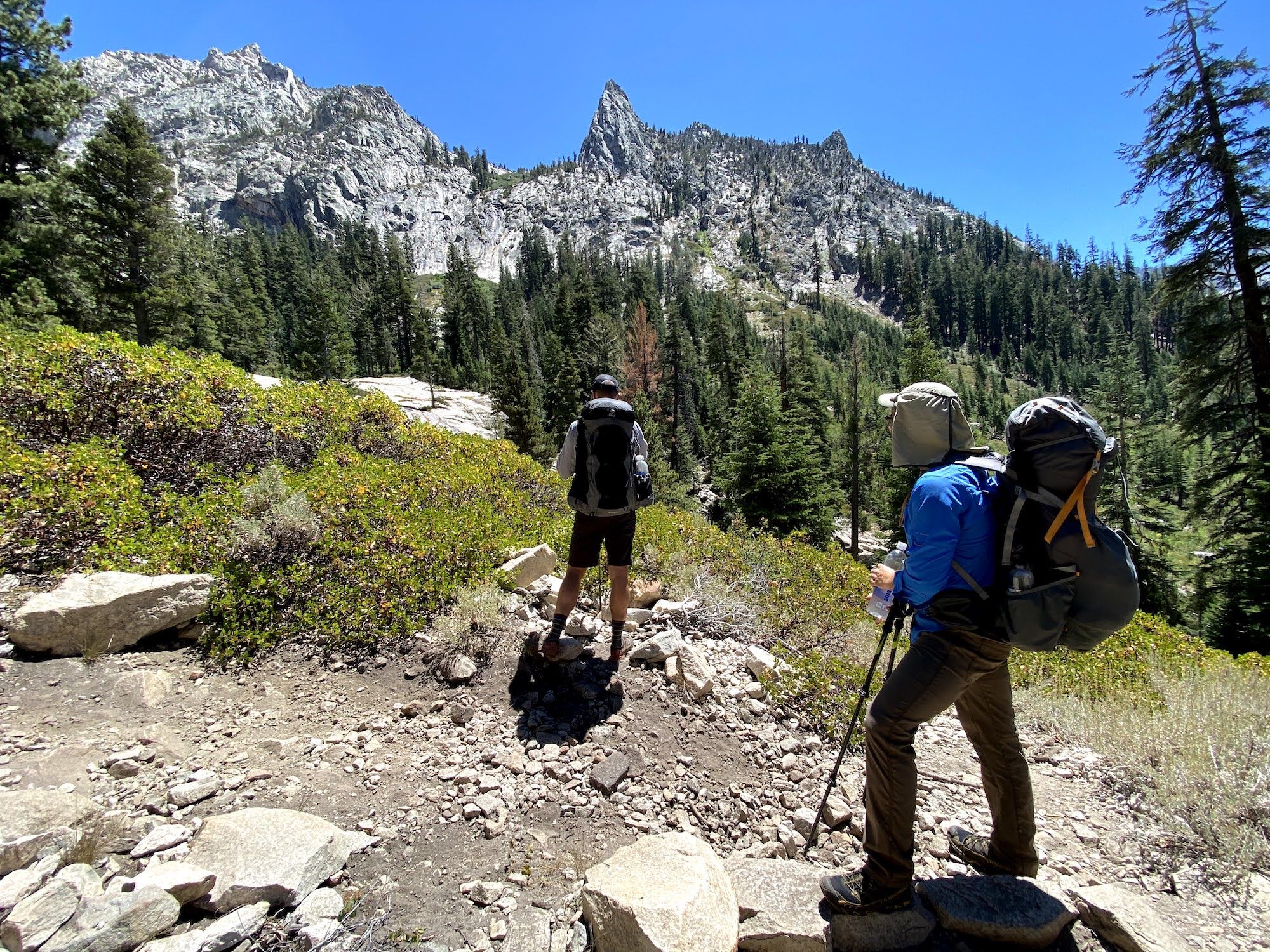 Two backpackers looking at the mountains