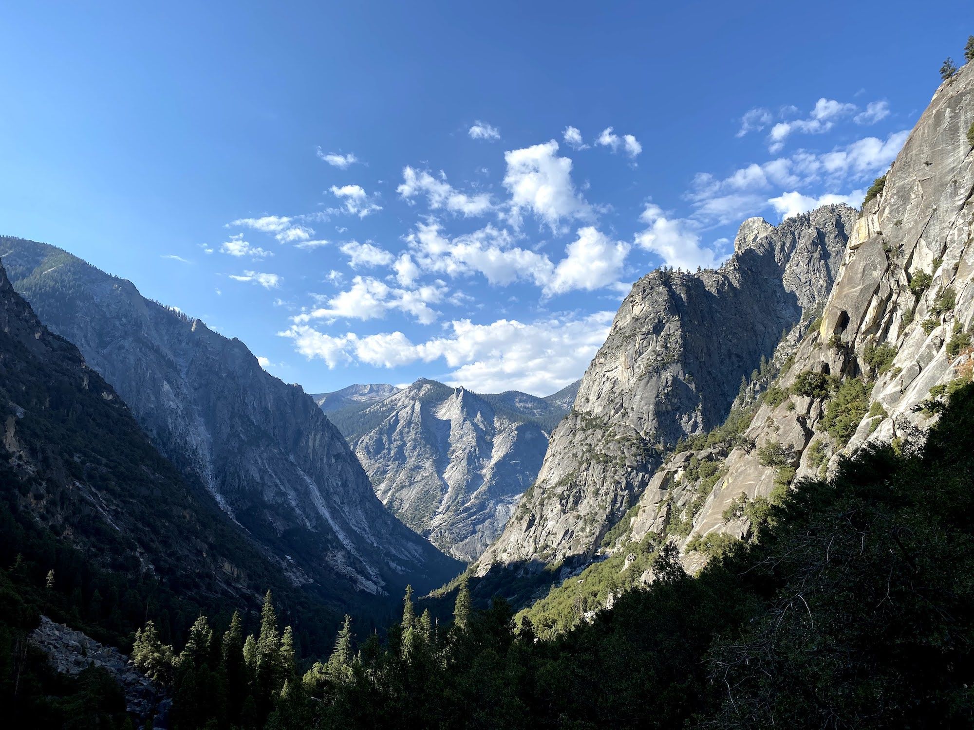 A deep mountain valley lit up by morning light. 