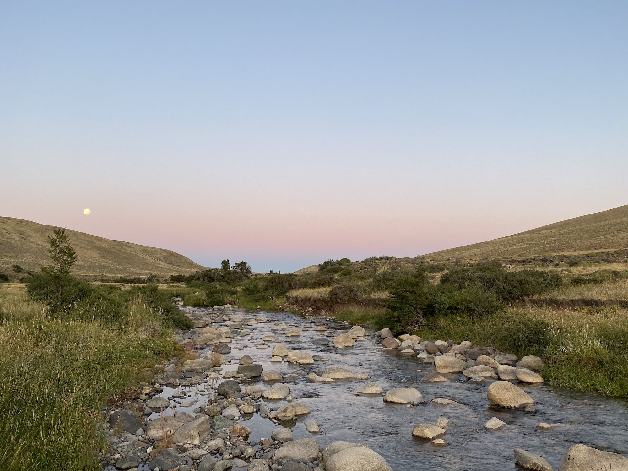 Sunset over a rocky stream.