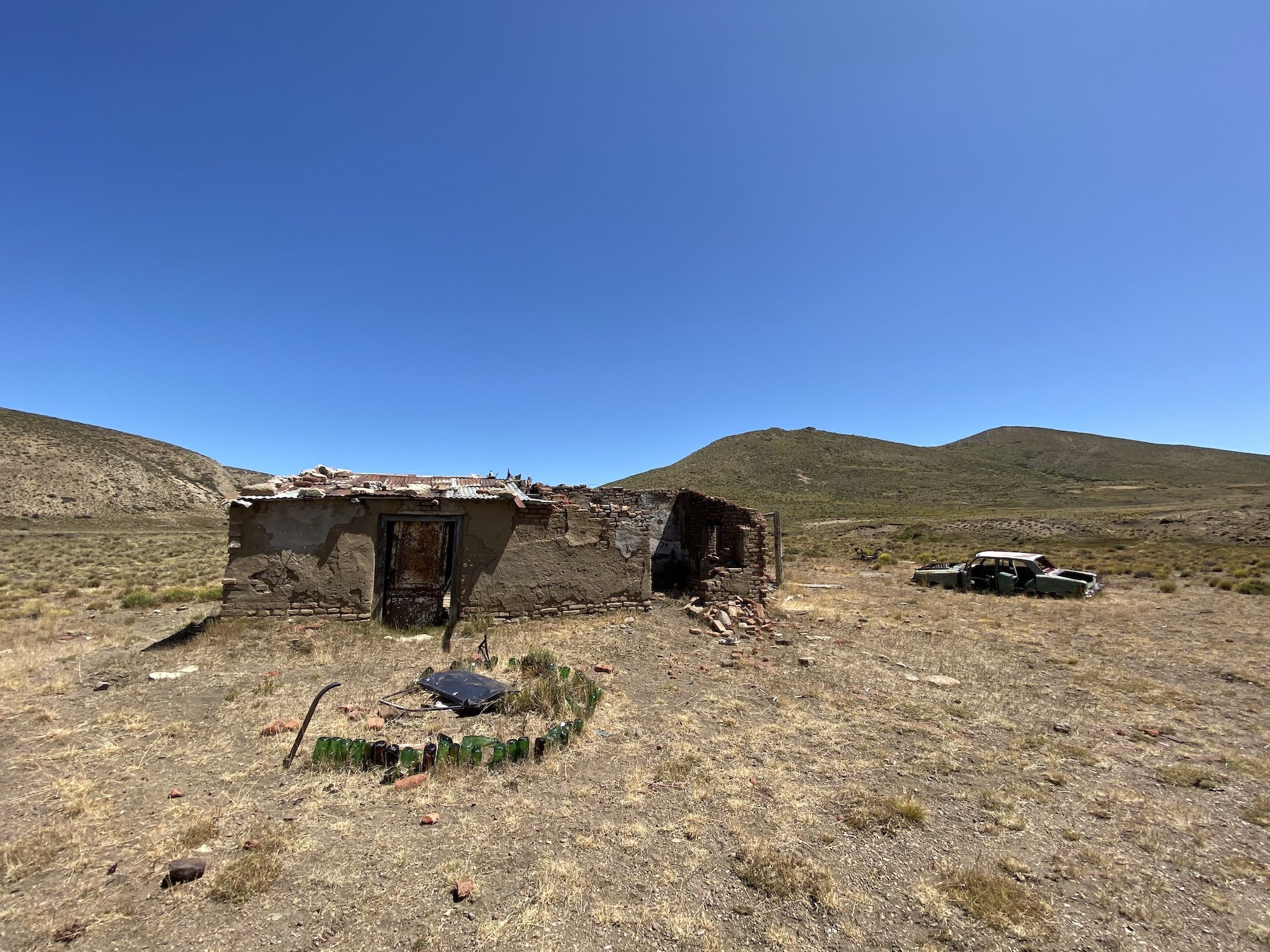 A dilapidated house and car