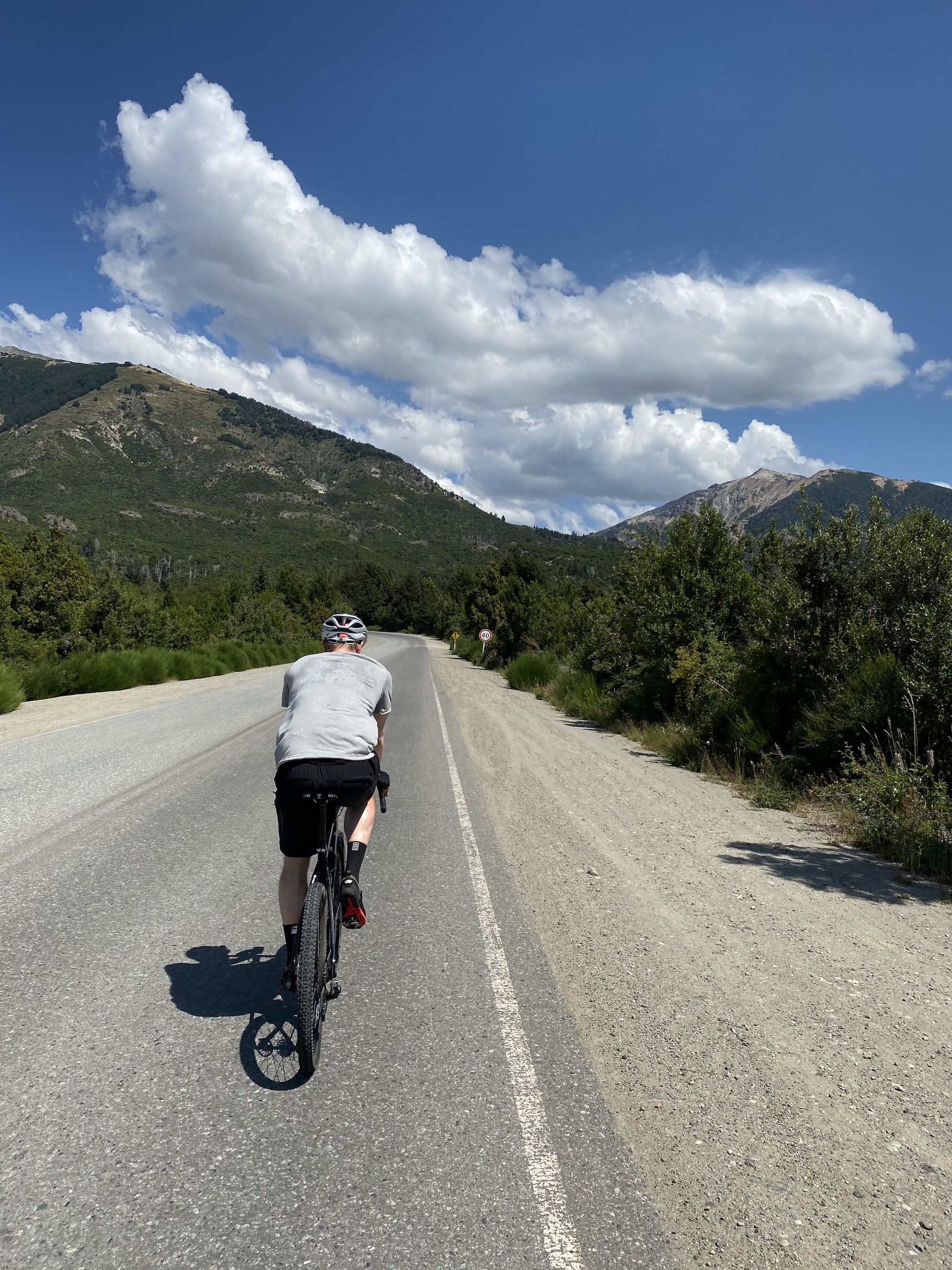 A man riding a bike on the side of a road