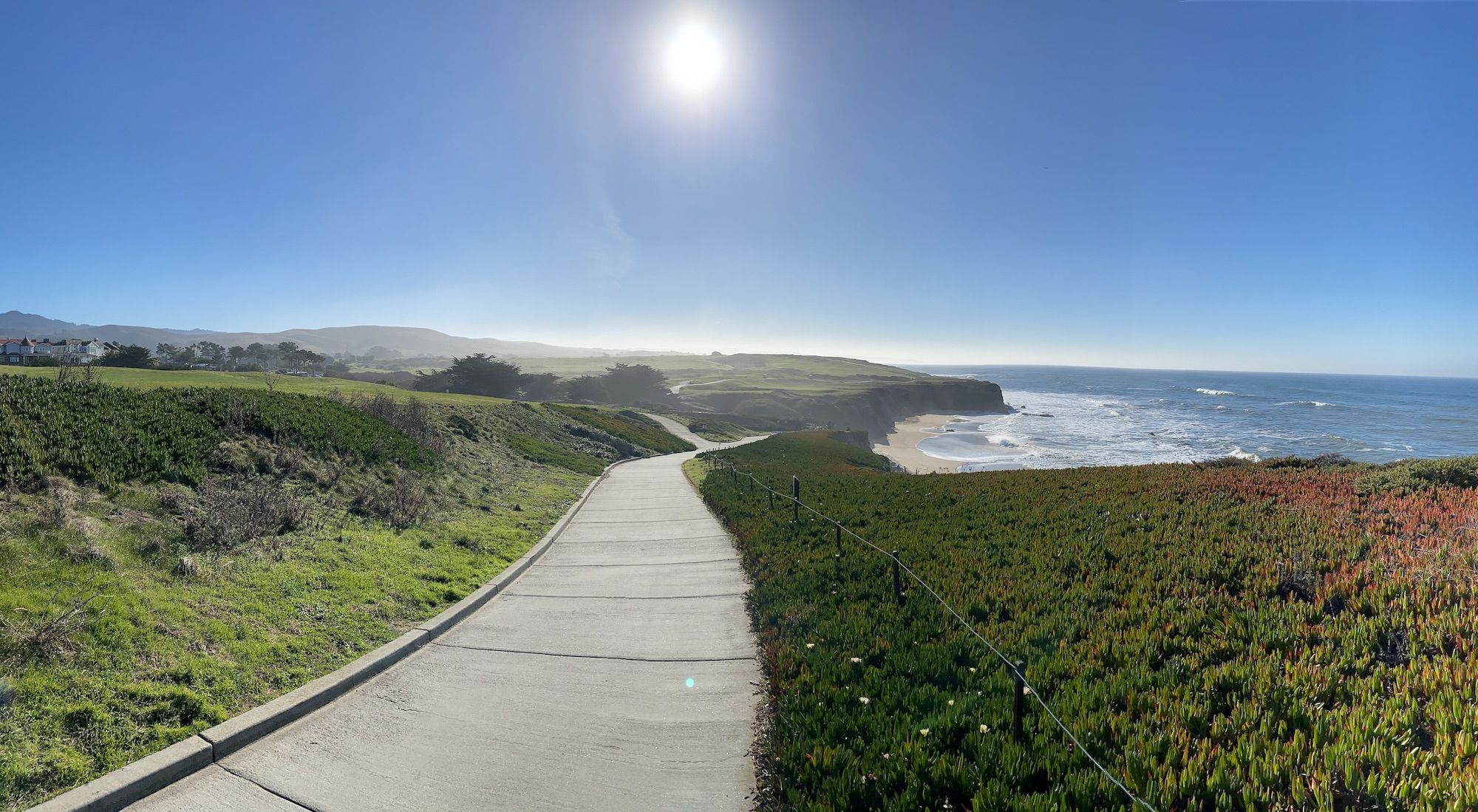 A well groomed trail between the coast and a golf course