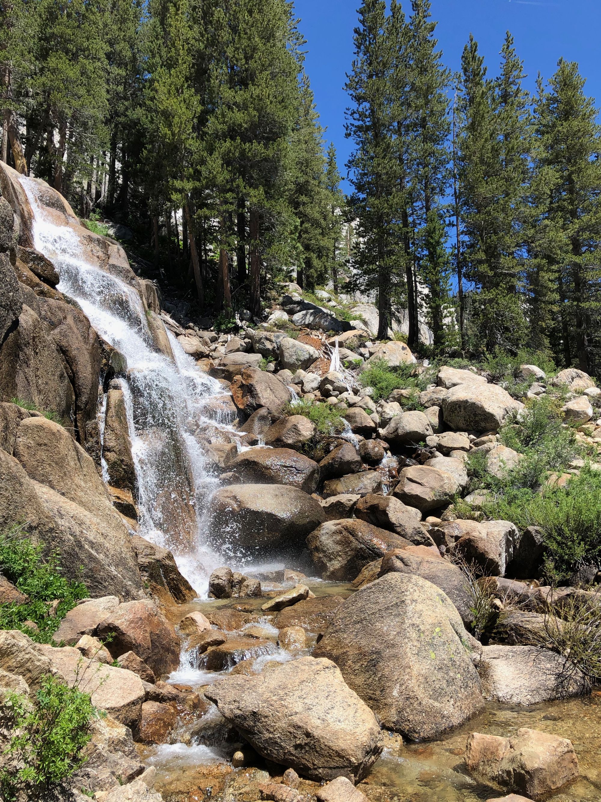 The trail went under a waterfall .