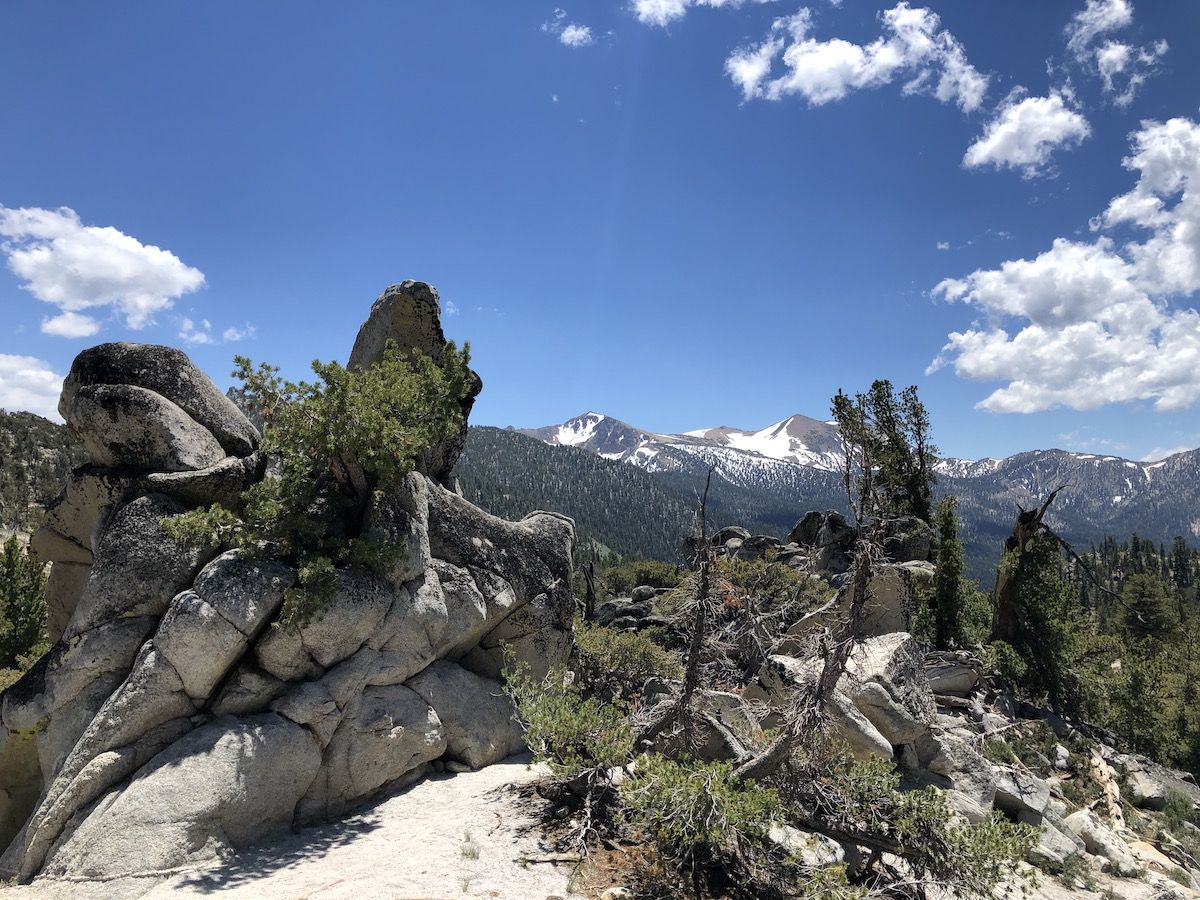 A rocky cliff with nice views in the background.