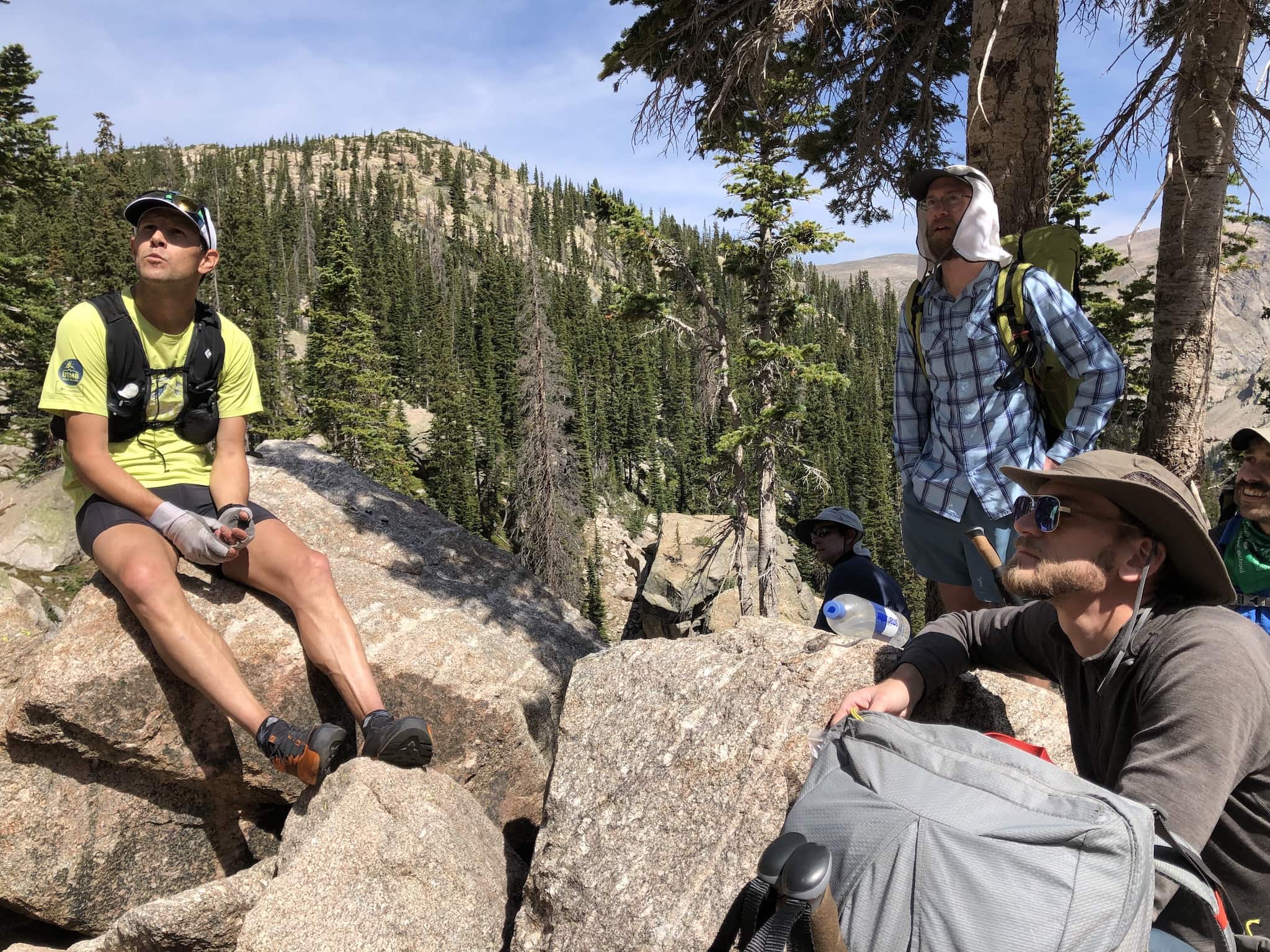 Andrew Skurka sitting on a rock talking to a group of backpackers.