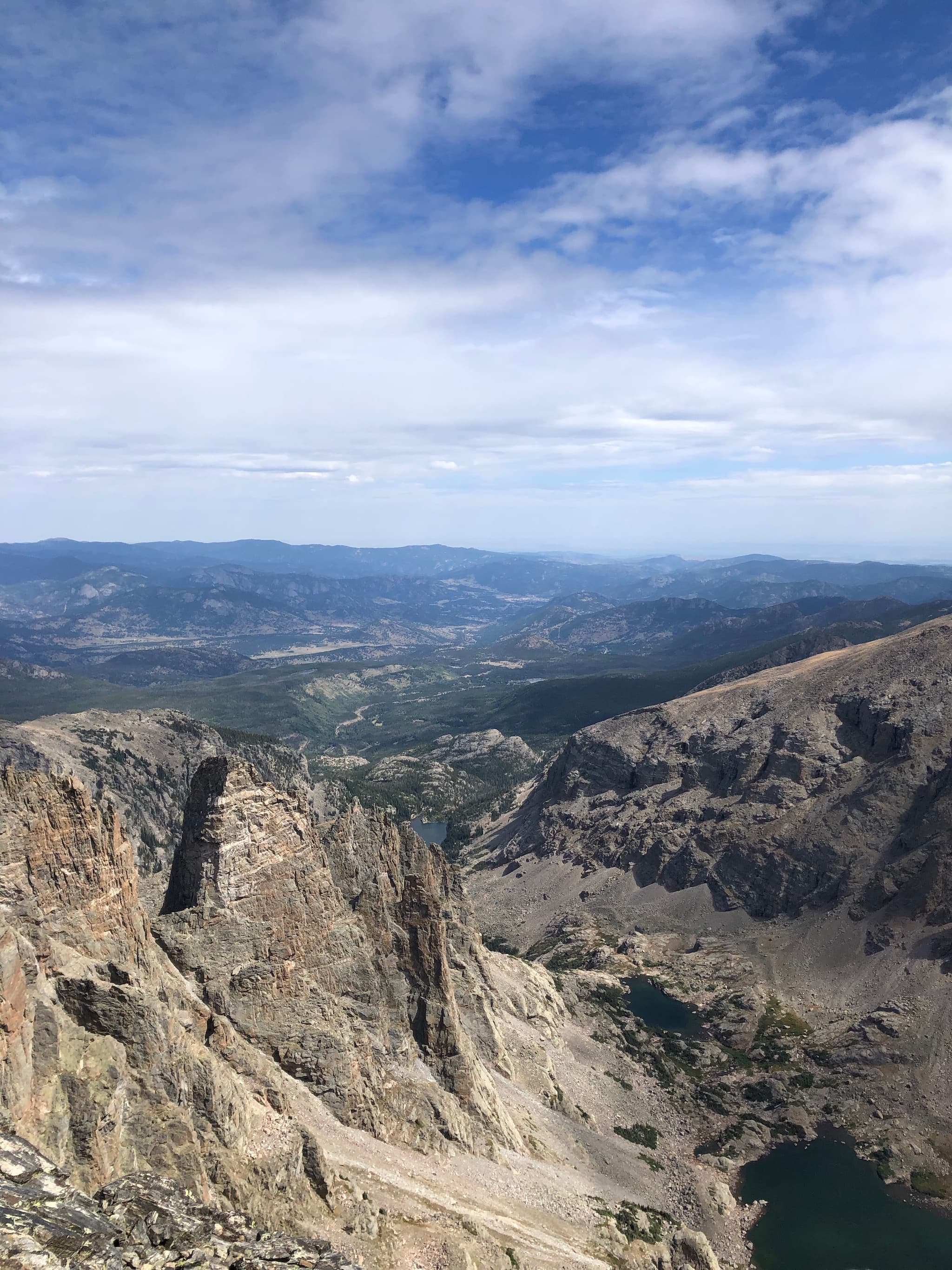 Sheer cliffs overlooking a valley in the distance.