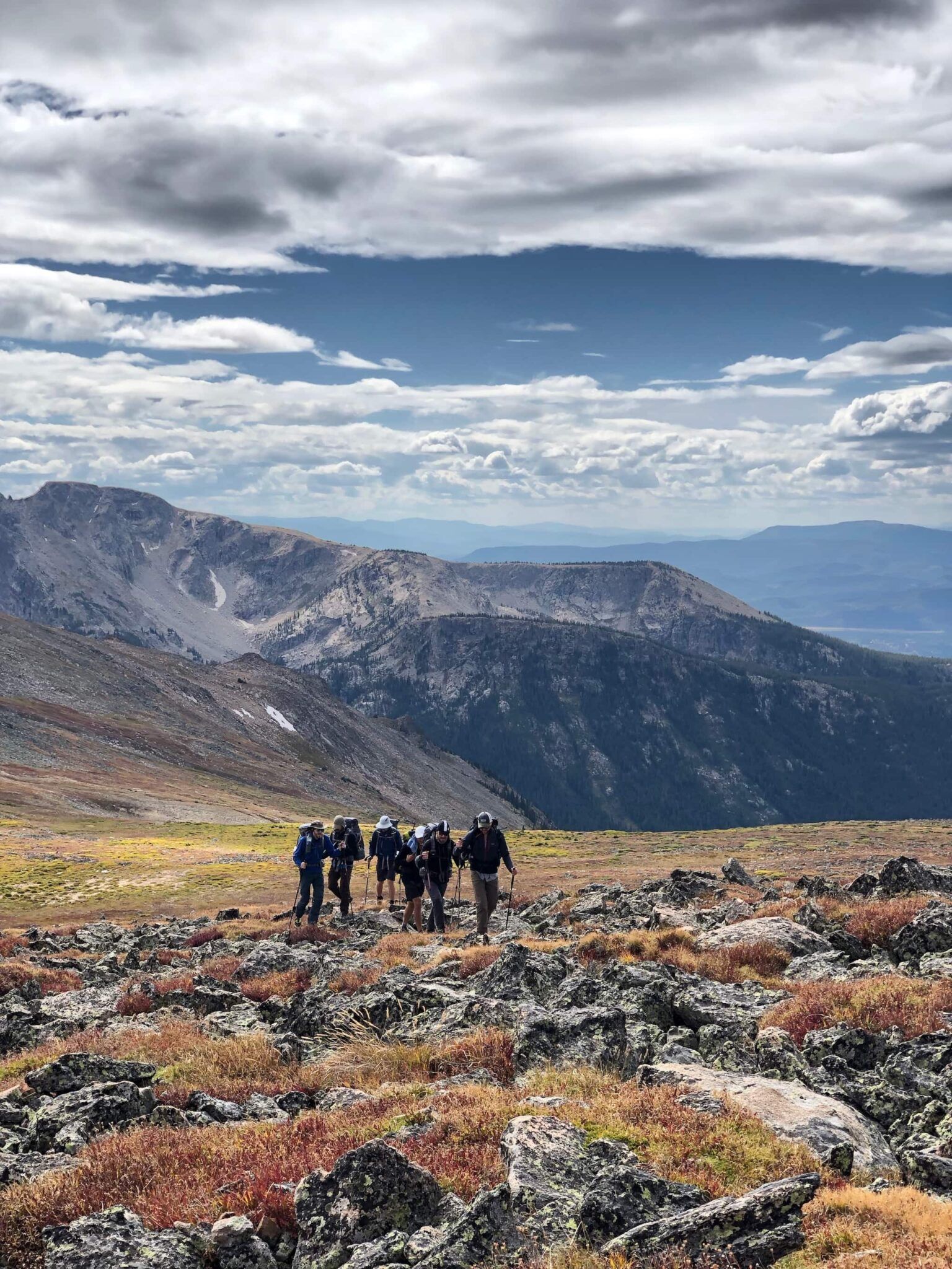 A group of hikers walking up a rocky slope