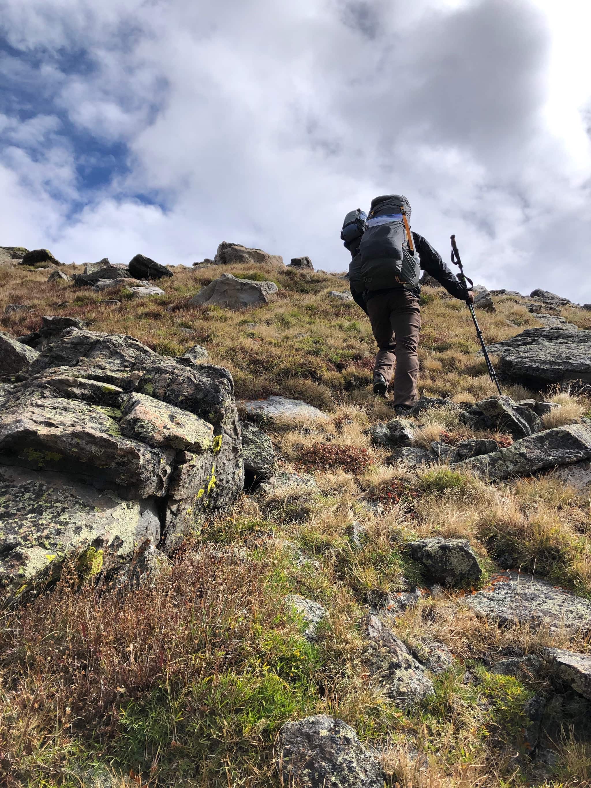 A man walking up a steep slope.