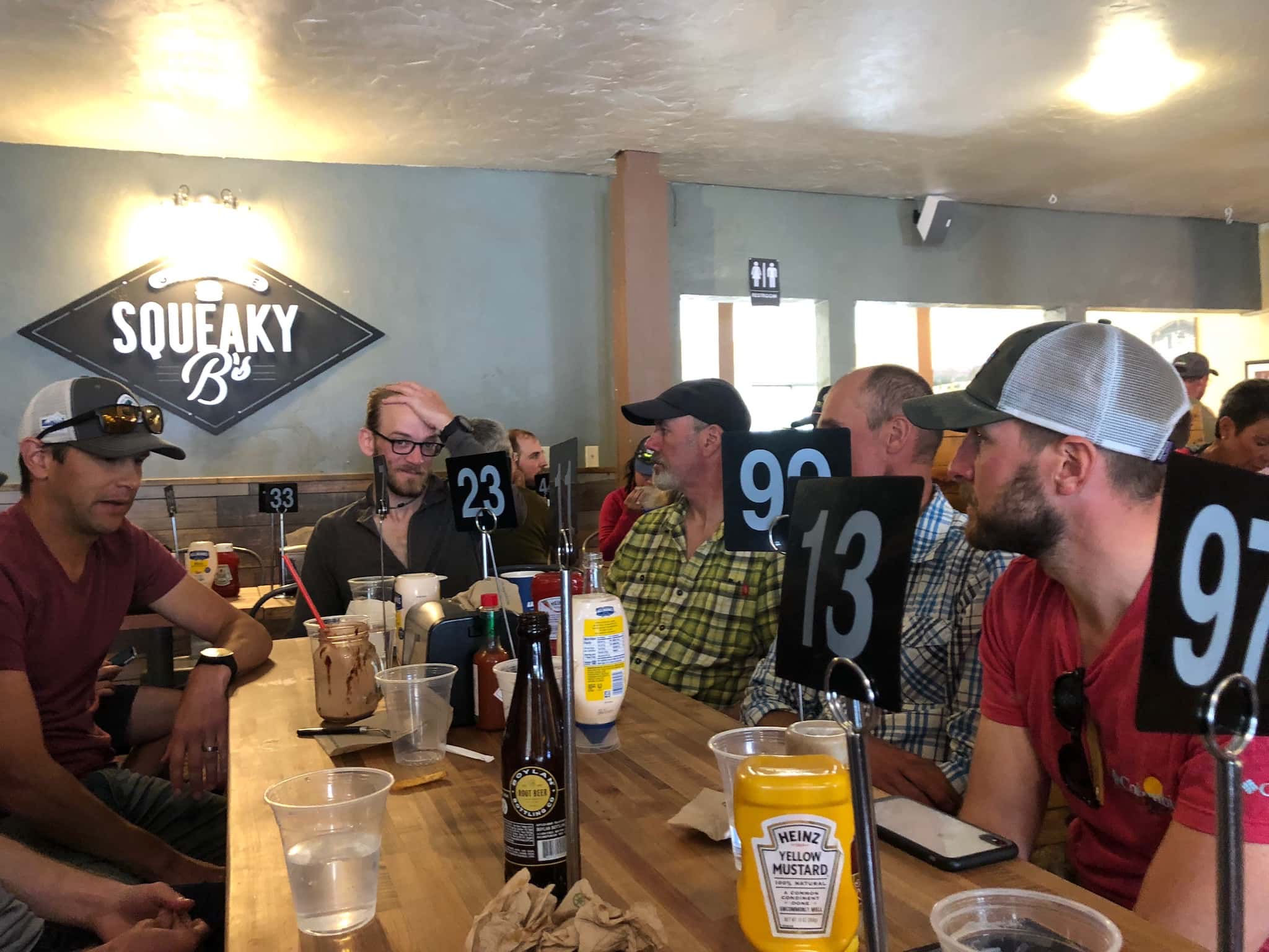 A group of men sitting around a restaurant table