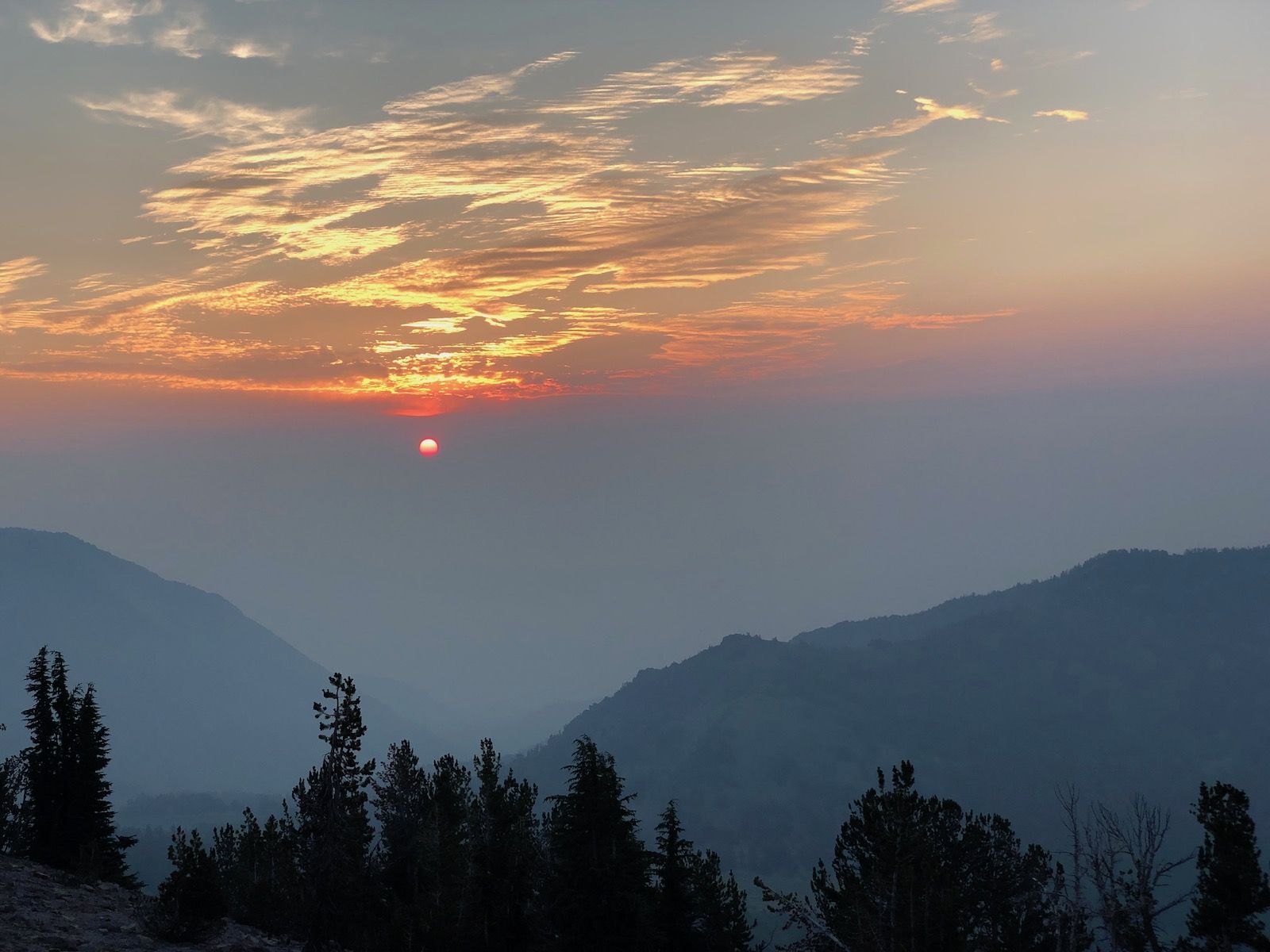 A smoky sunrise on Relay Peak.