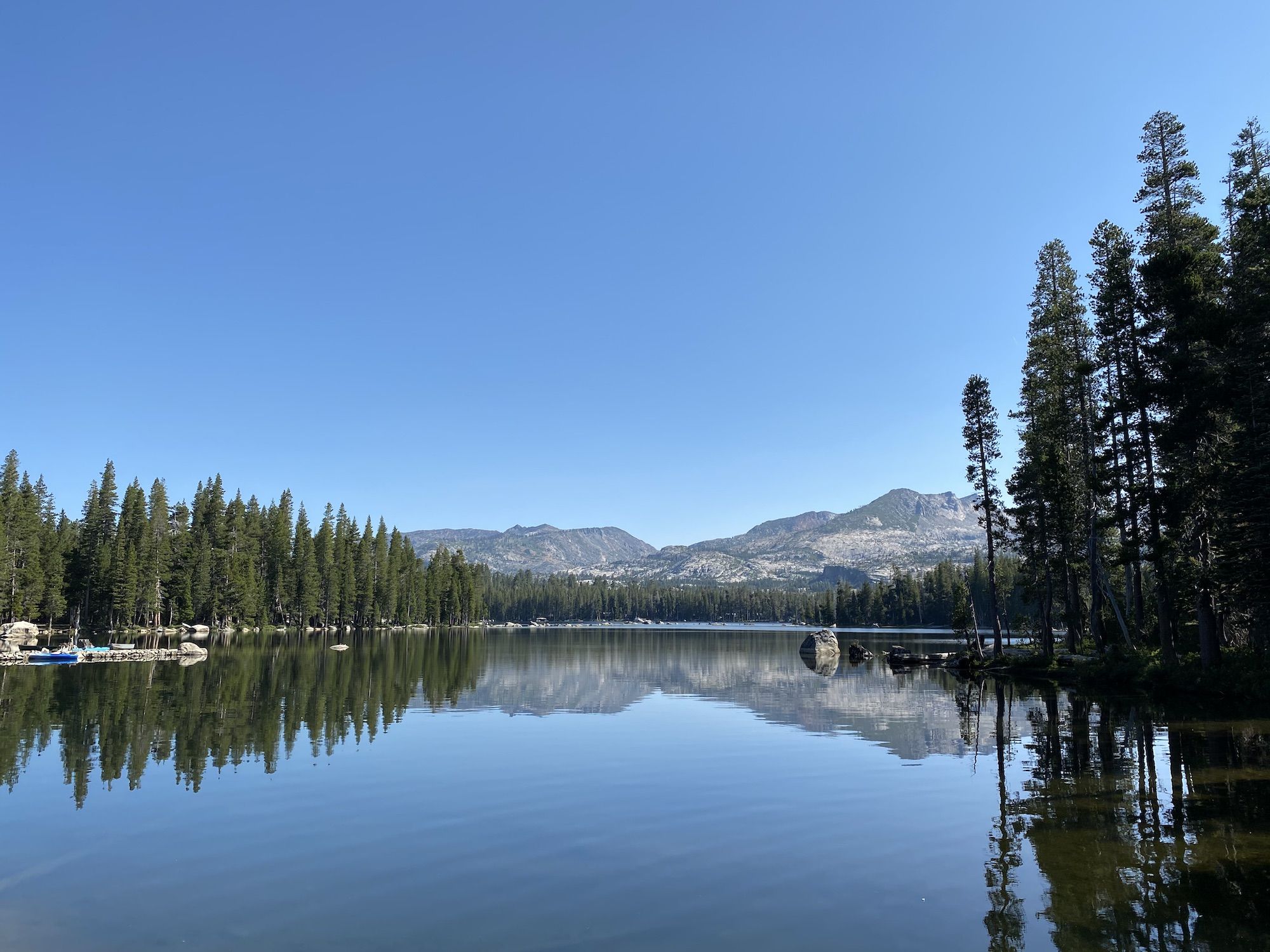 A calm lake reflecting mountains