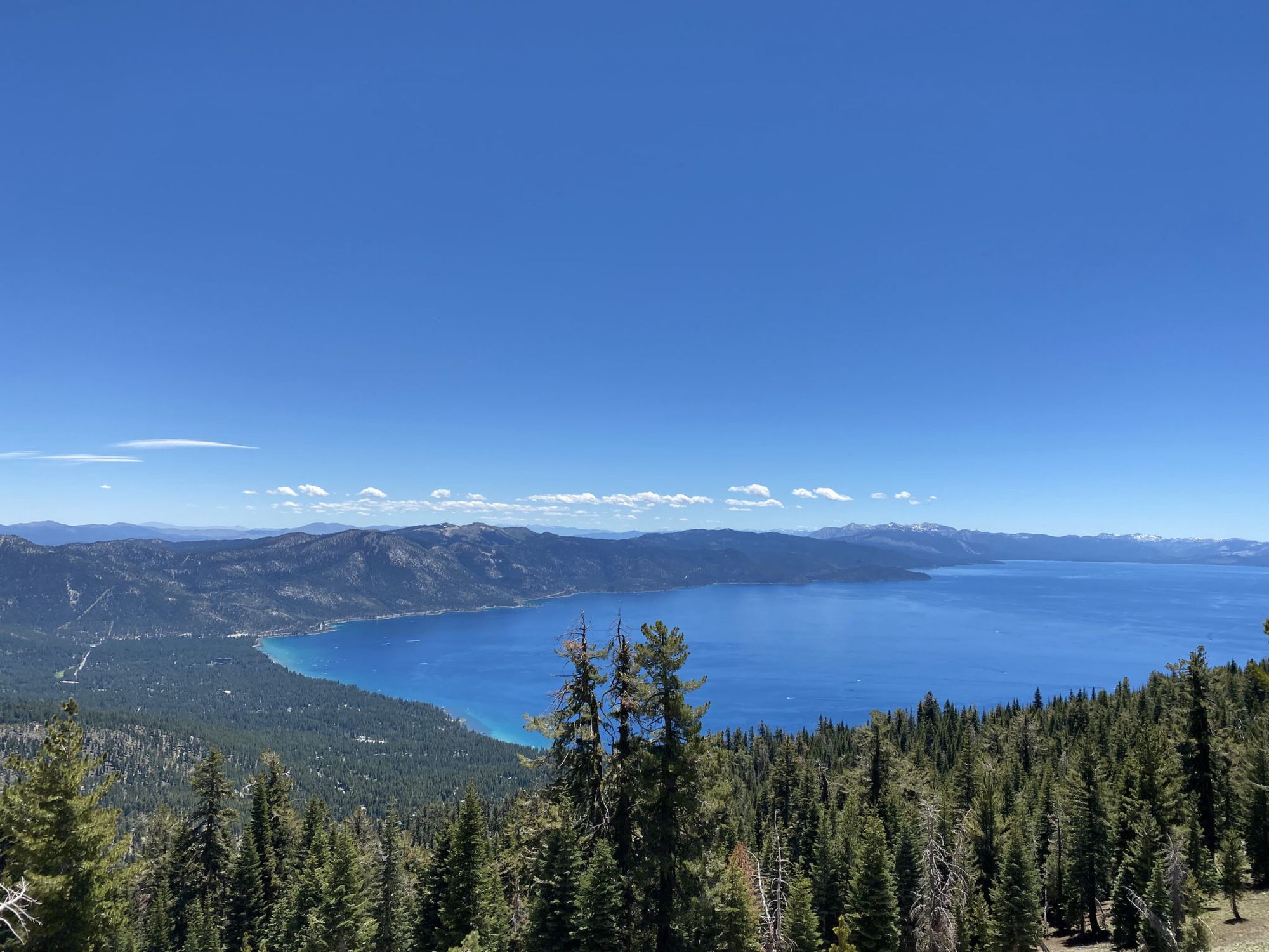 A lake with turquoise water along the shore