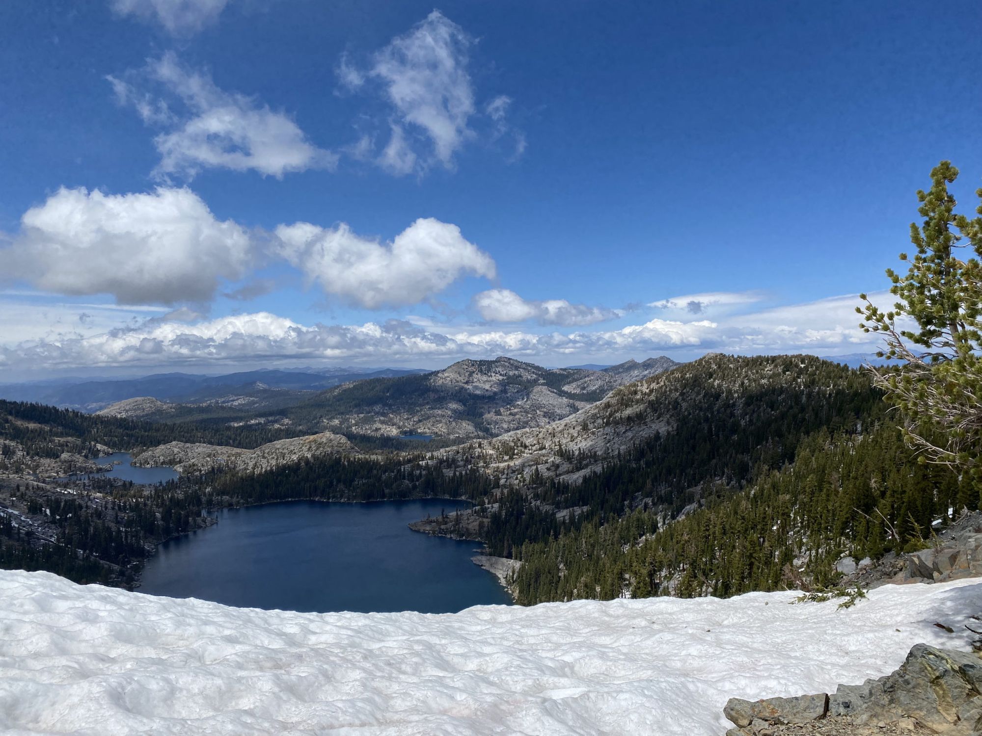 Two lakes in the distance. A snow bank in the foreground.