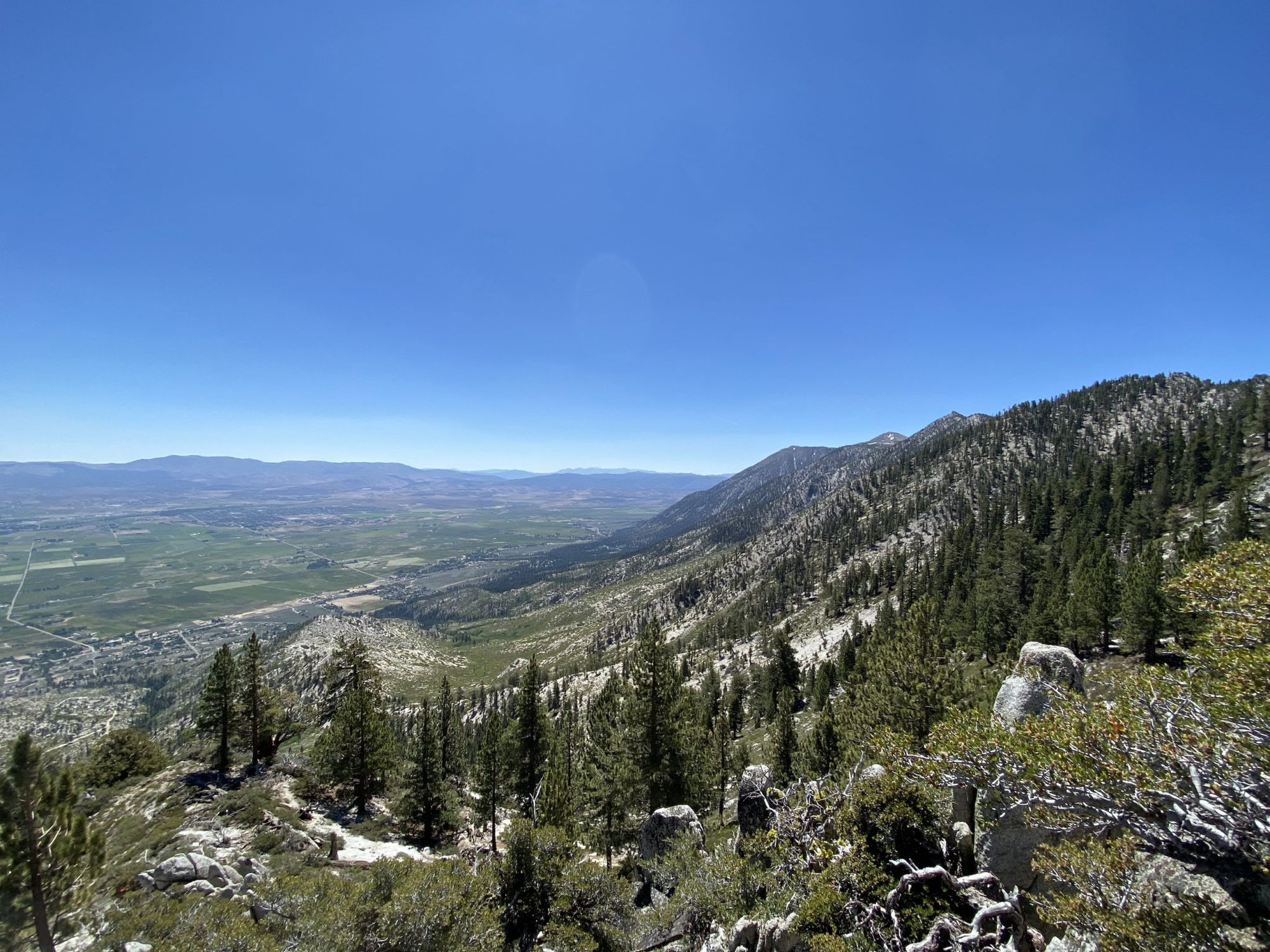 Views of a valley covered in farmland and roads. 