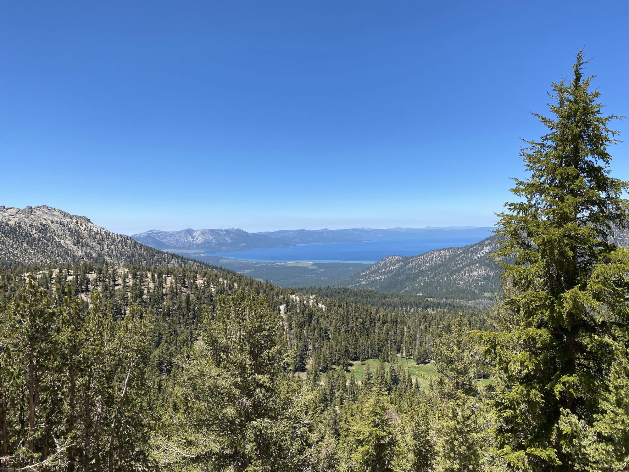 A large lake behind layers of mountains