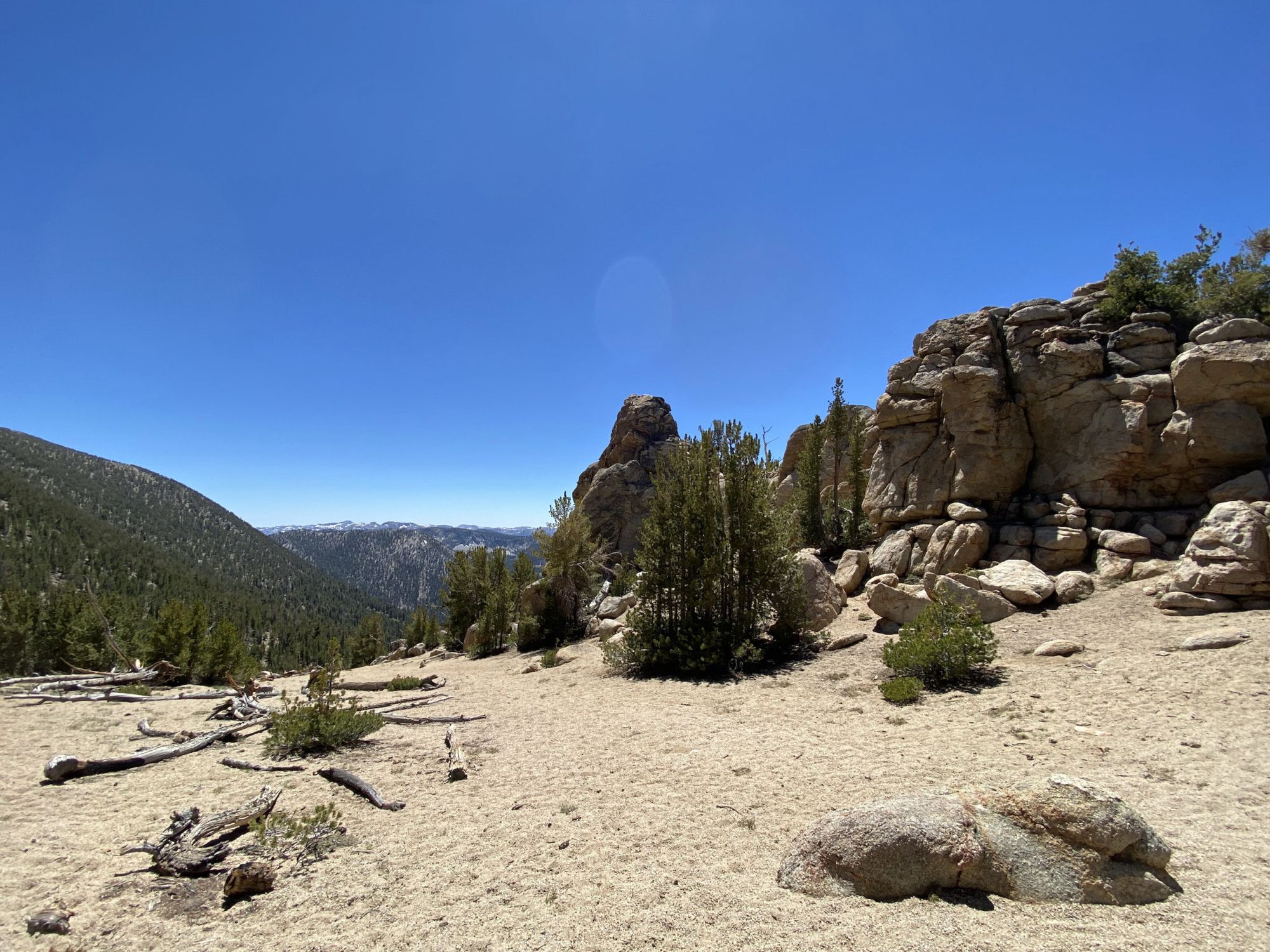 Sand in the foreground, rock formations in the background