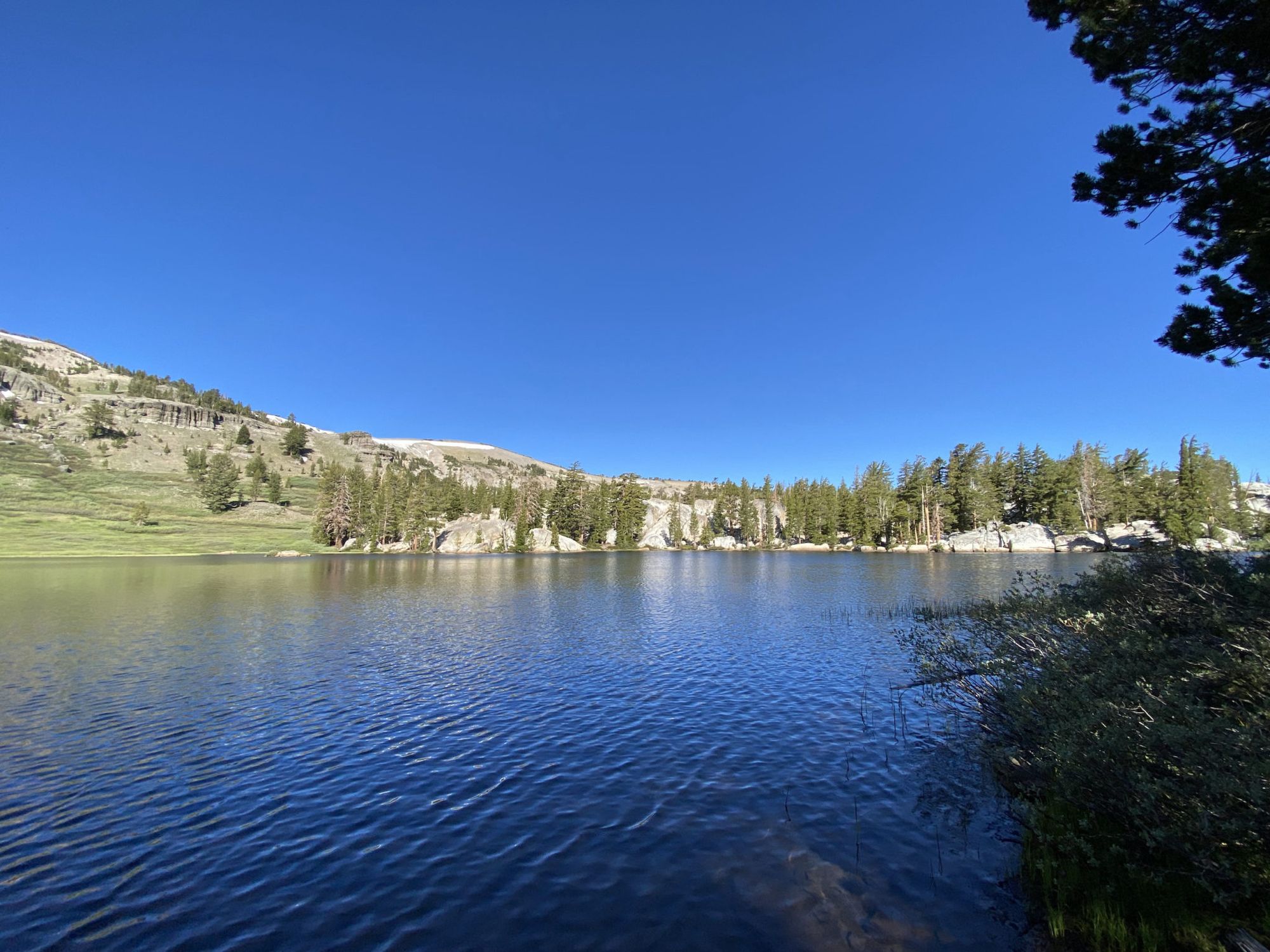 An alpine lake with a rocky shore