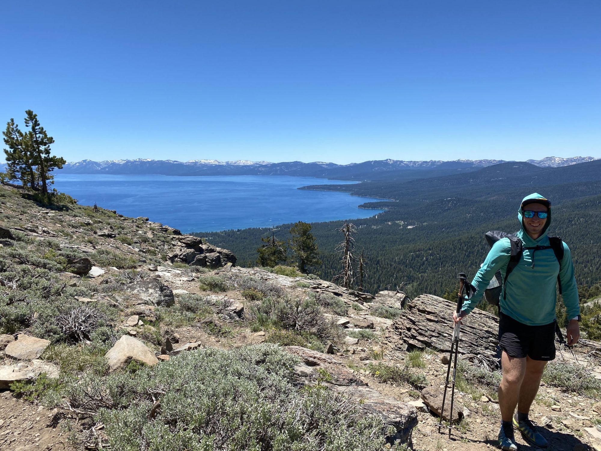 A hiker at a cliff overlooking Lake Tahoe