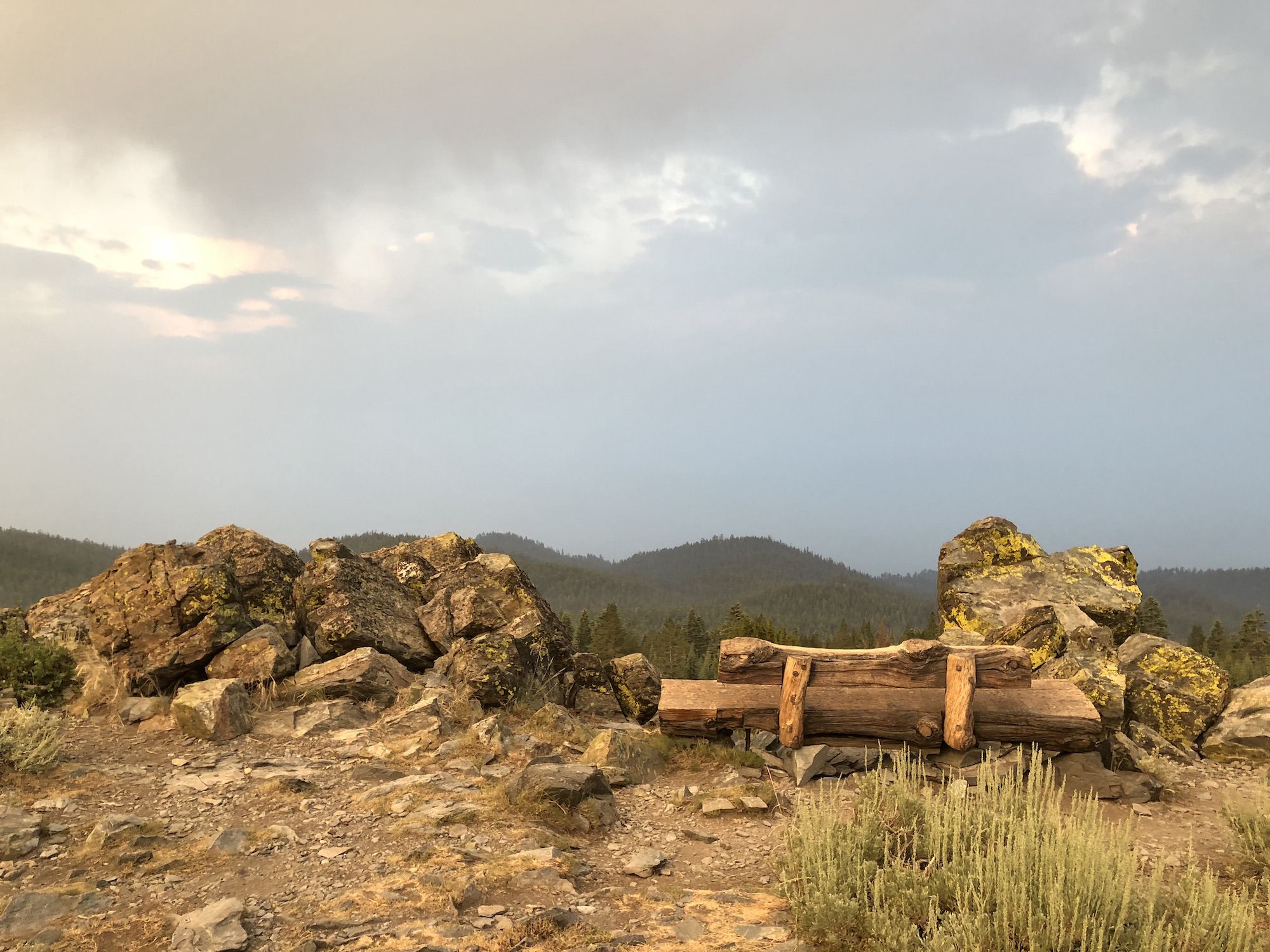 The iconic Tahoe Rim Trail bench overlooking a smoky horizon