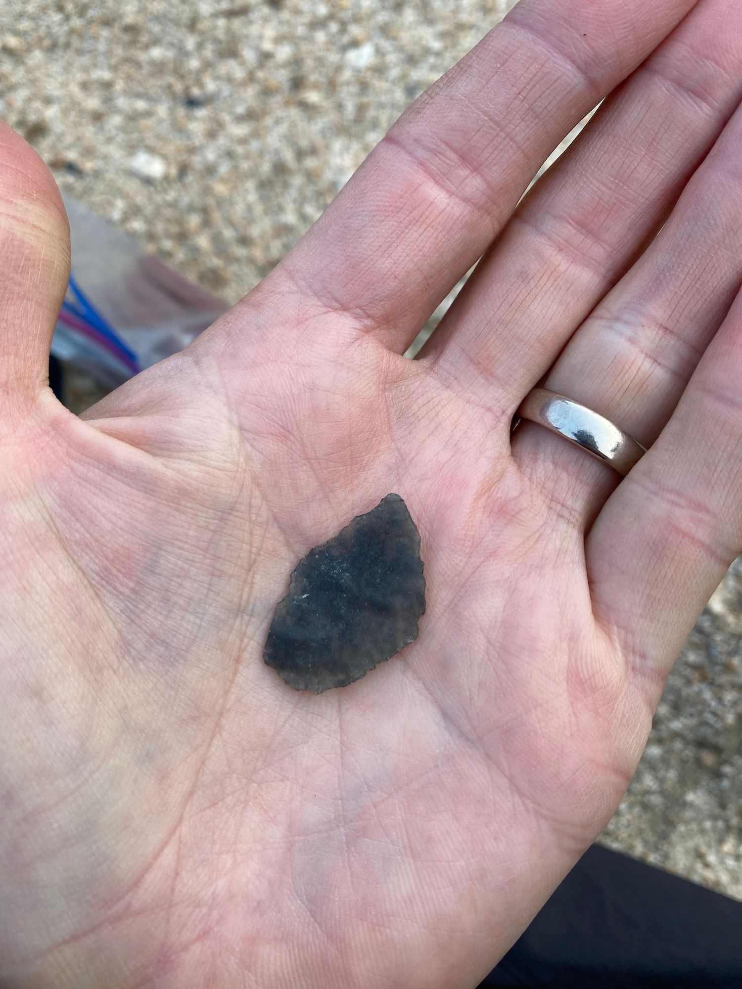 An arrowhead in the palm of a hand. 