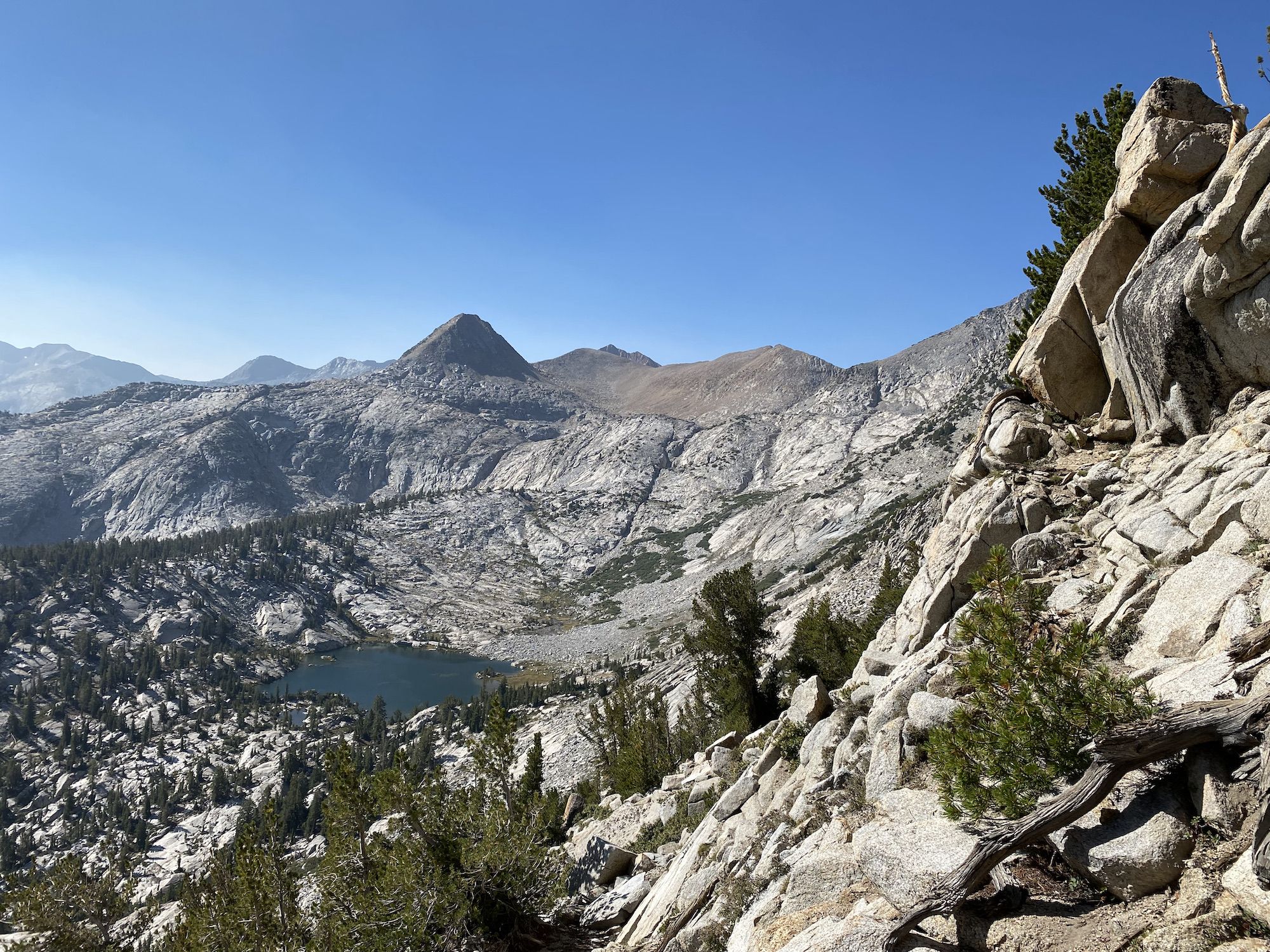 A lake in a bowl surrounded by granite peaks.