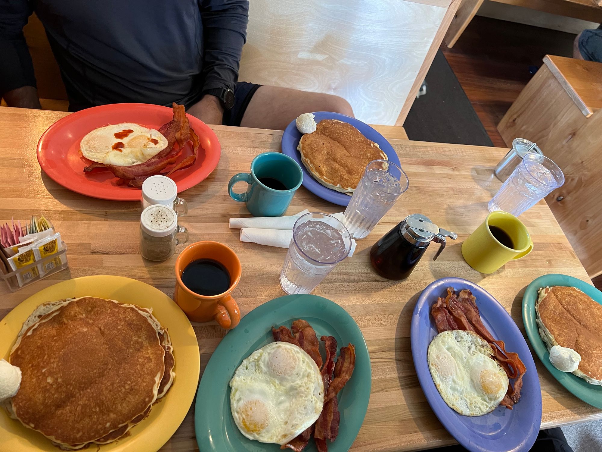 Three plates each of: pancakes, bacon, and eggs.