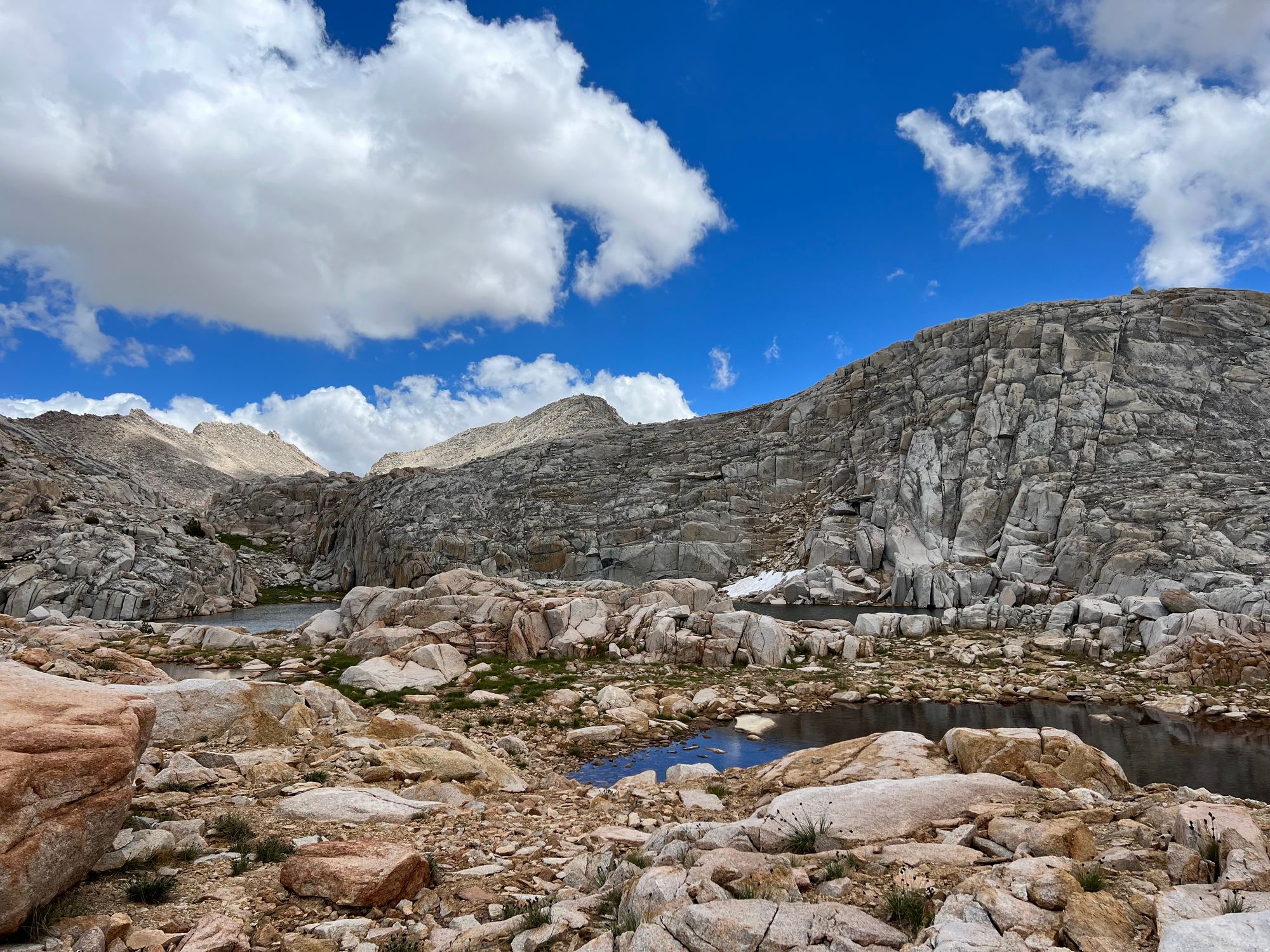 Small ponds of water among rugged granite.