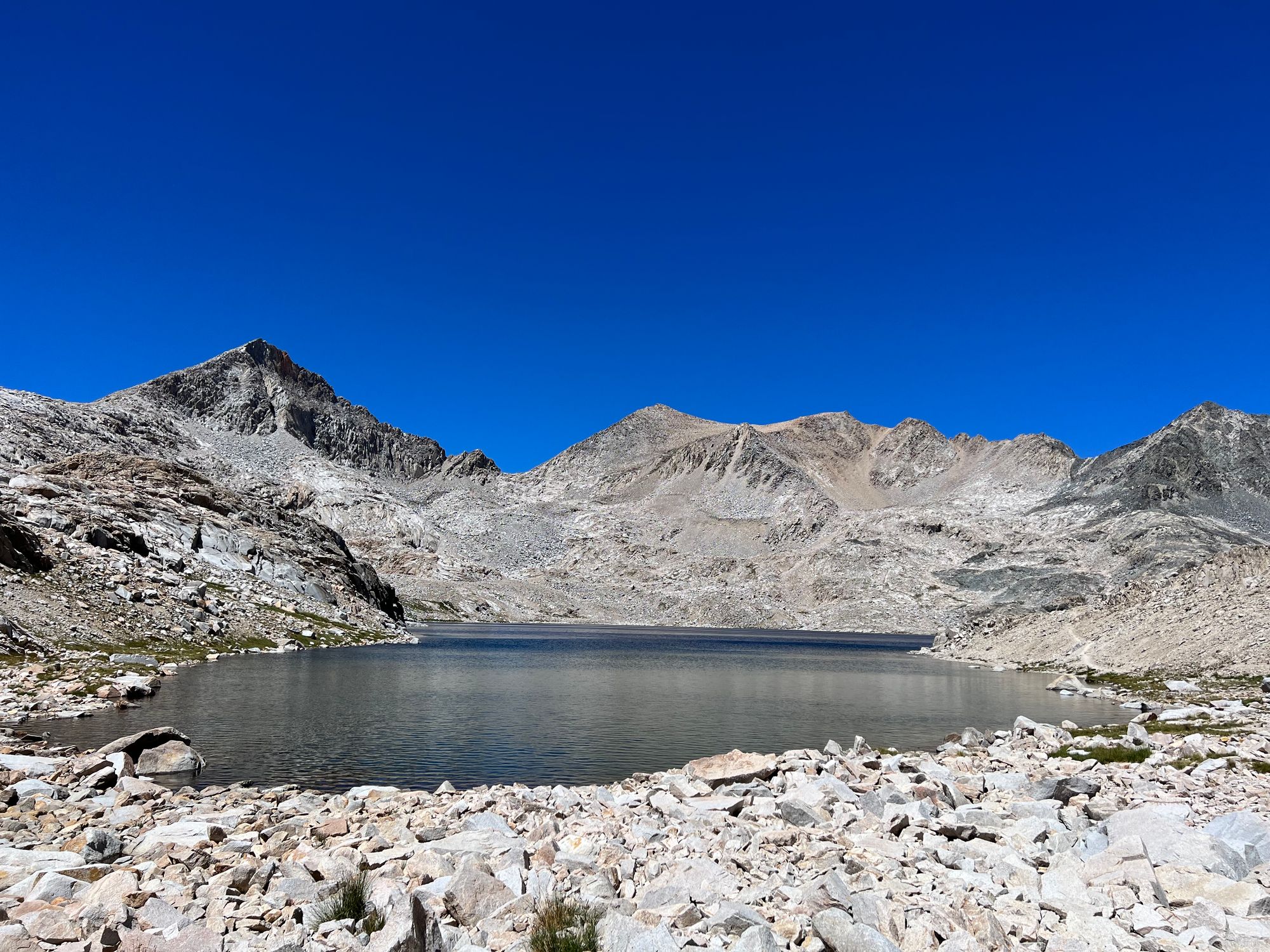 A deep-blue lake nestled between mountains.