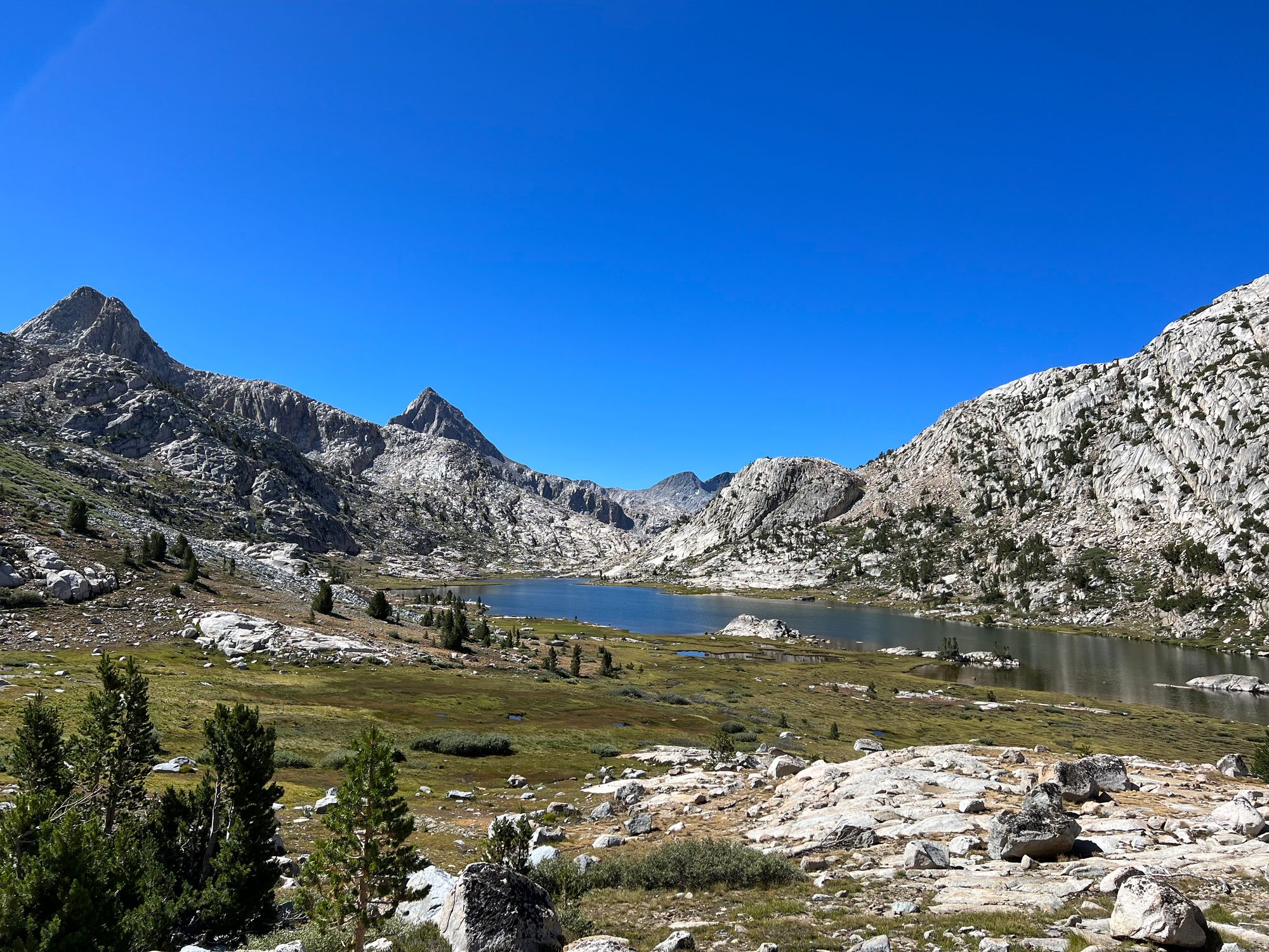 A lake surrounded by tall granite mountains. 