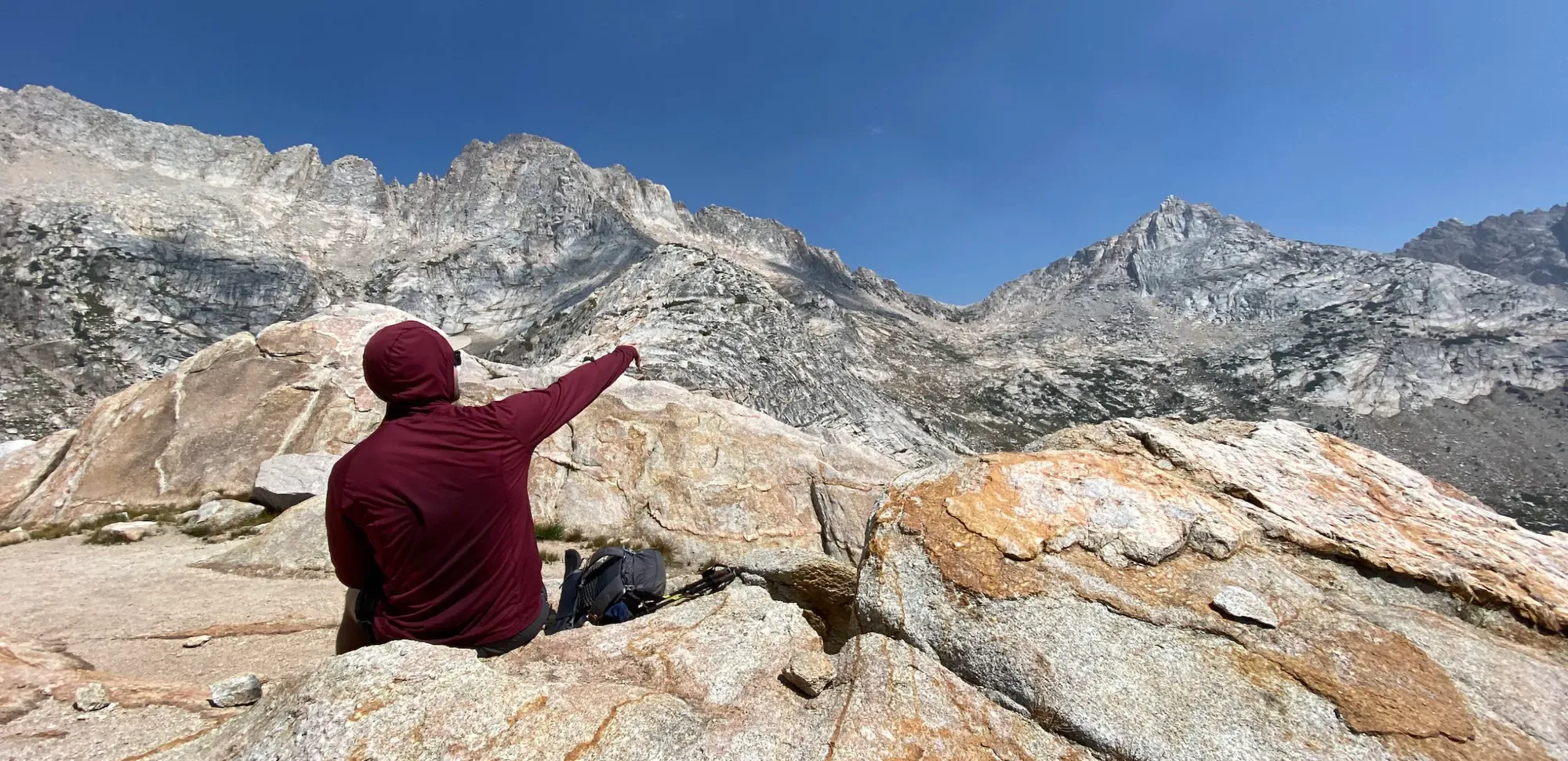 Man pointing at a mountain pass